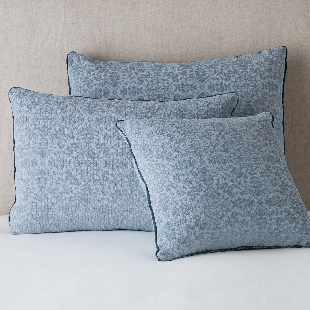 [allvariants]: Vienna shams leaning upright against a neutral headboard - mineral.