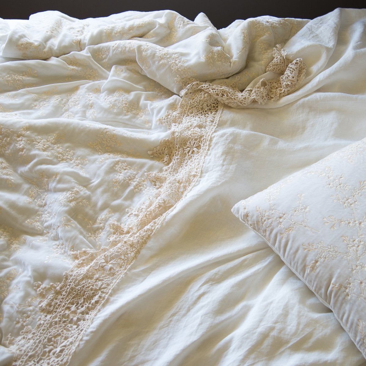: Lynette's gold embroidery in winter white beautifully complements our linen with cotton lace in the same hue - close-up overhead angle.