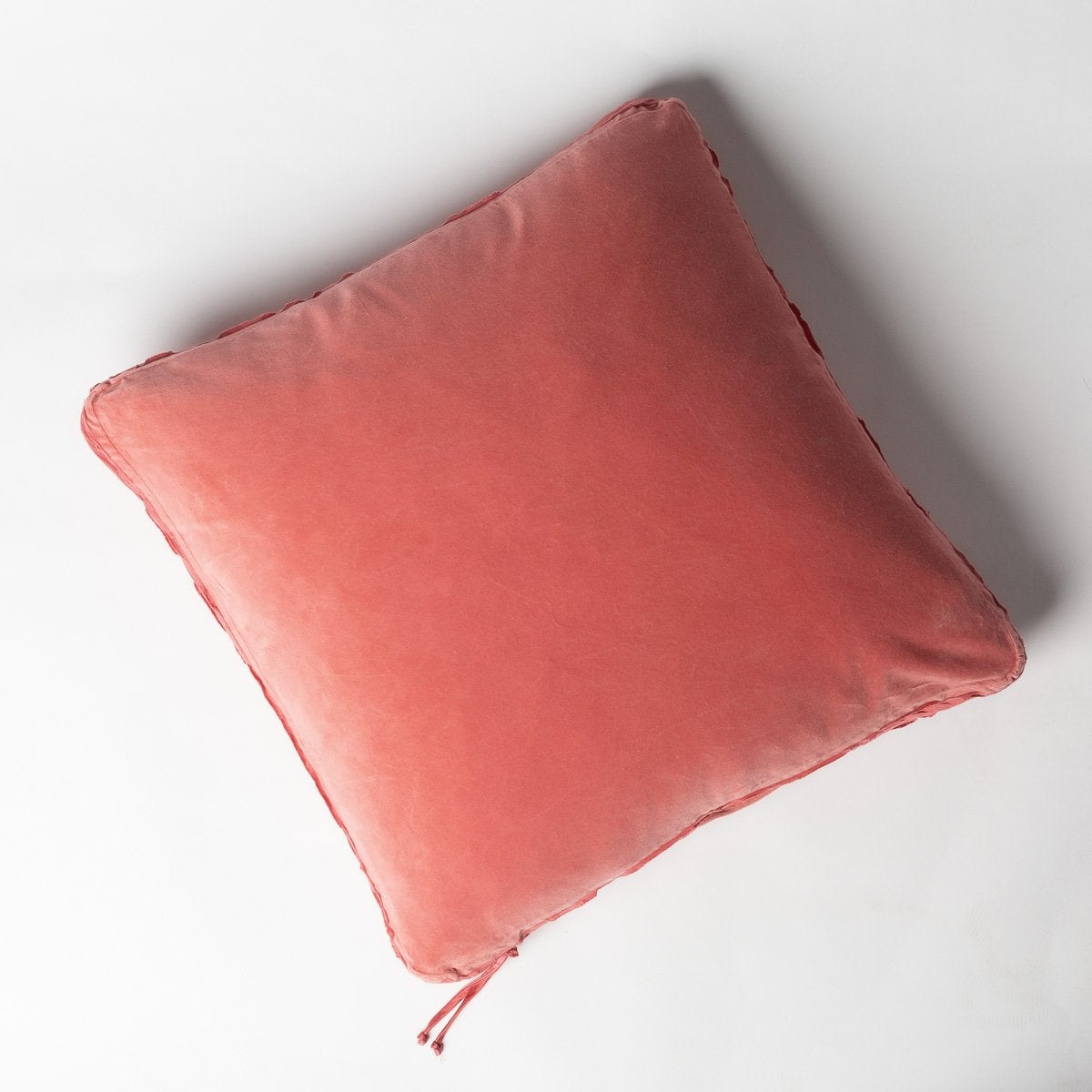 Poppy: Cotton velvet 24 by 24 pillow on a plain background - overhead view.