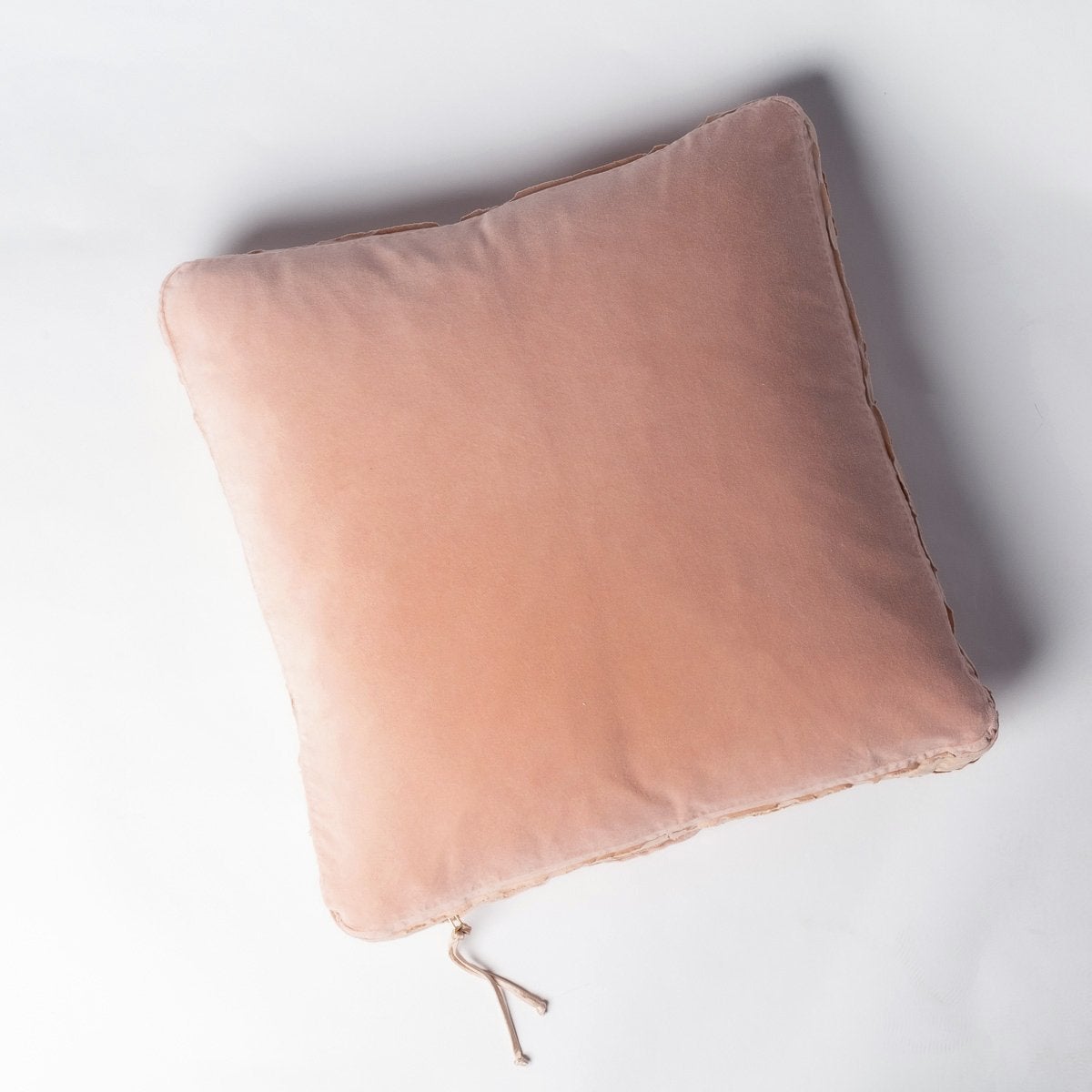 Rouge: Harlow 24 by 24 pillow in rouge on a plain background - overhead view.