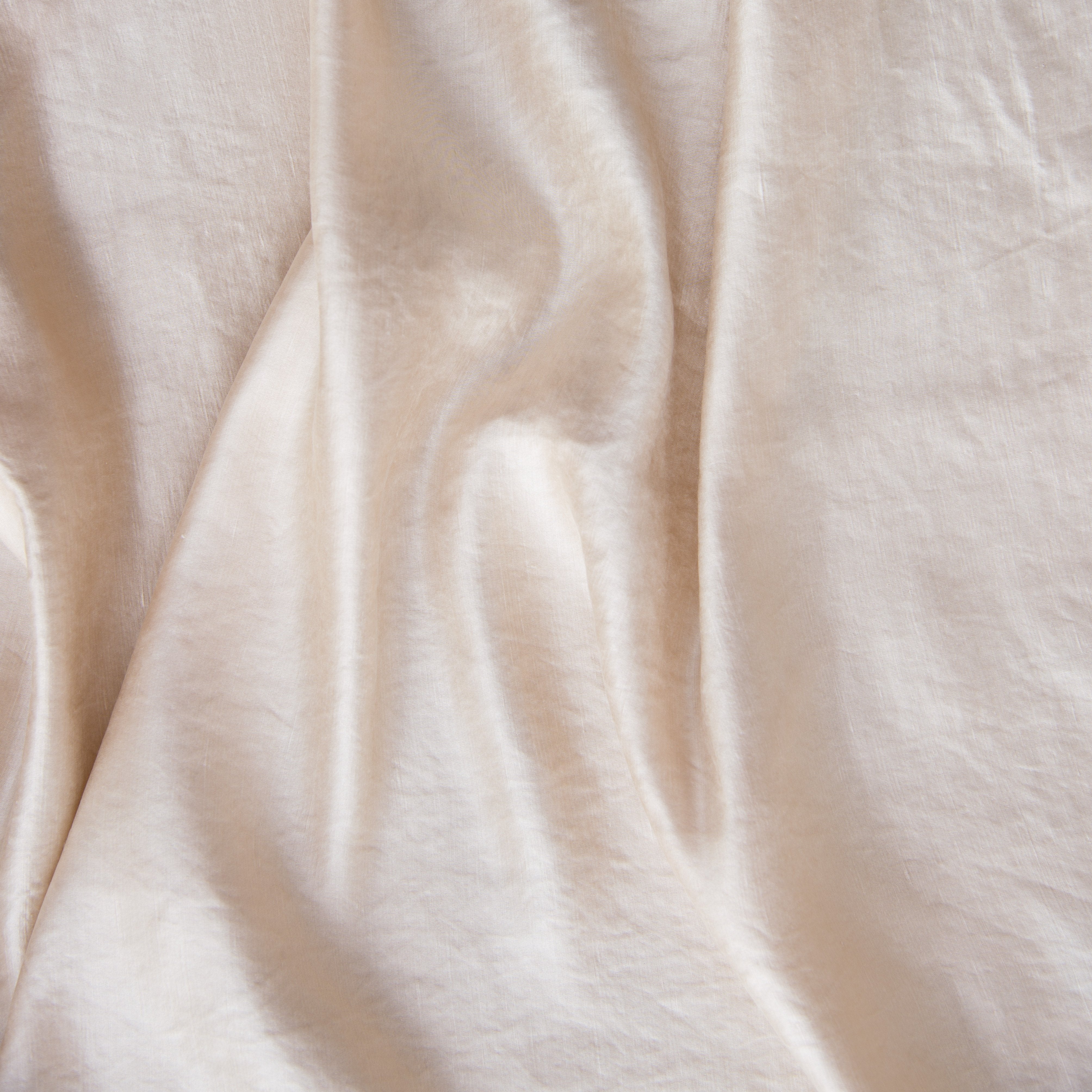 Pearl: Close-up of silk charmeuse in pearl, a nude-like, soft rose pink tone. 
