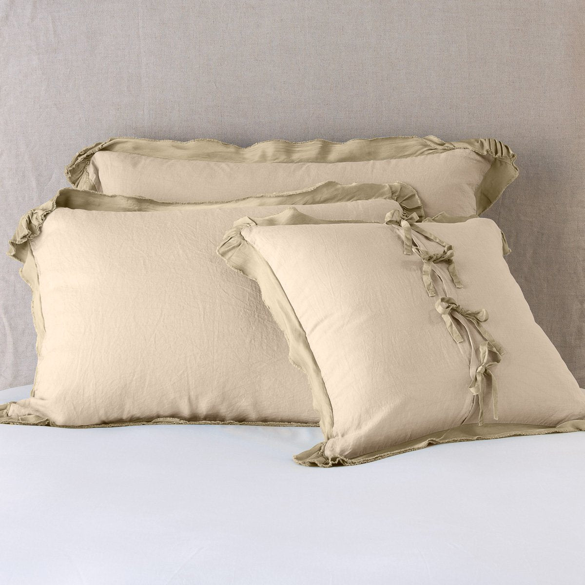Honeycomb: satin trimmed linen shams showing the front and back of the sham with tie closures. 