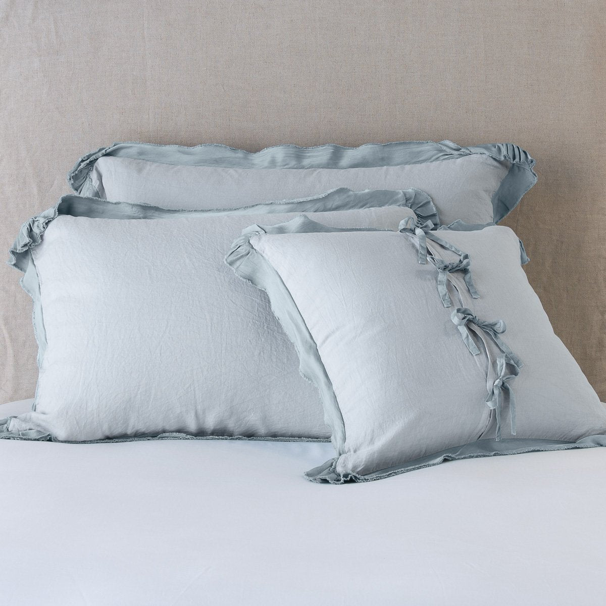 Mineral: satin trimmed linen shams showing the front and back of the sham with tie closures. 
