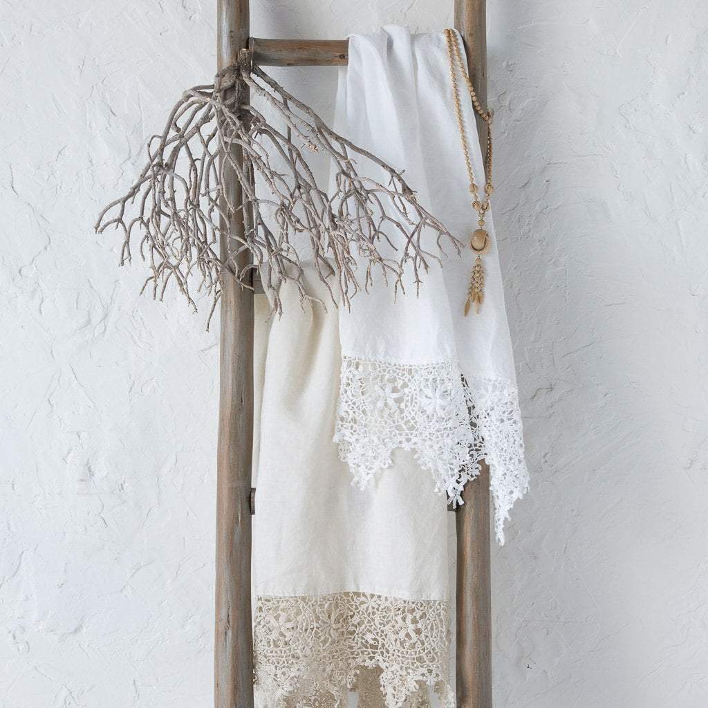 : Frida guest towels in white and winter white, draped over a decorative wooden ladder.