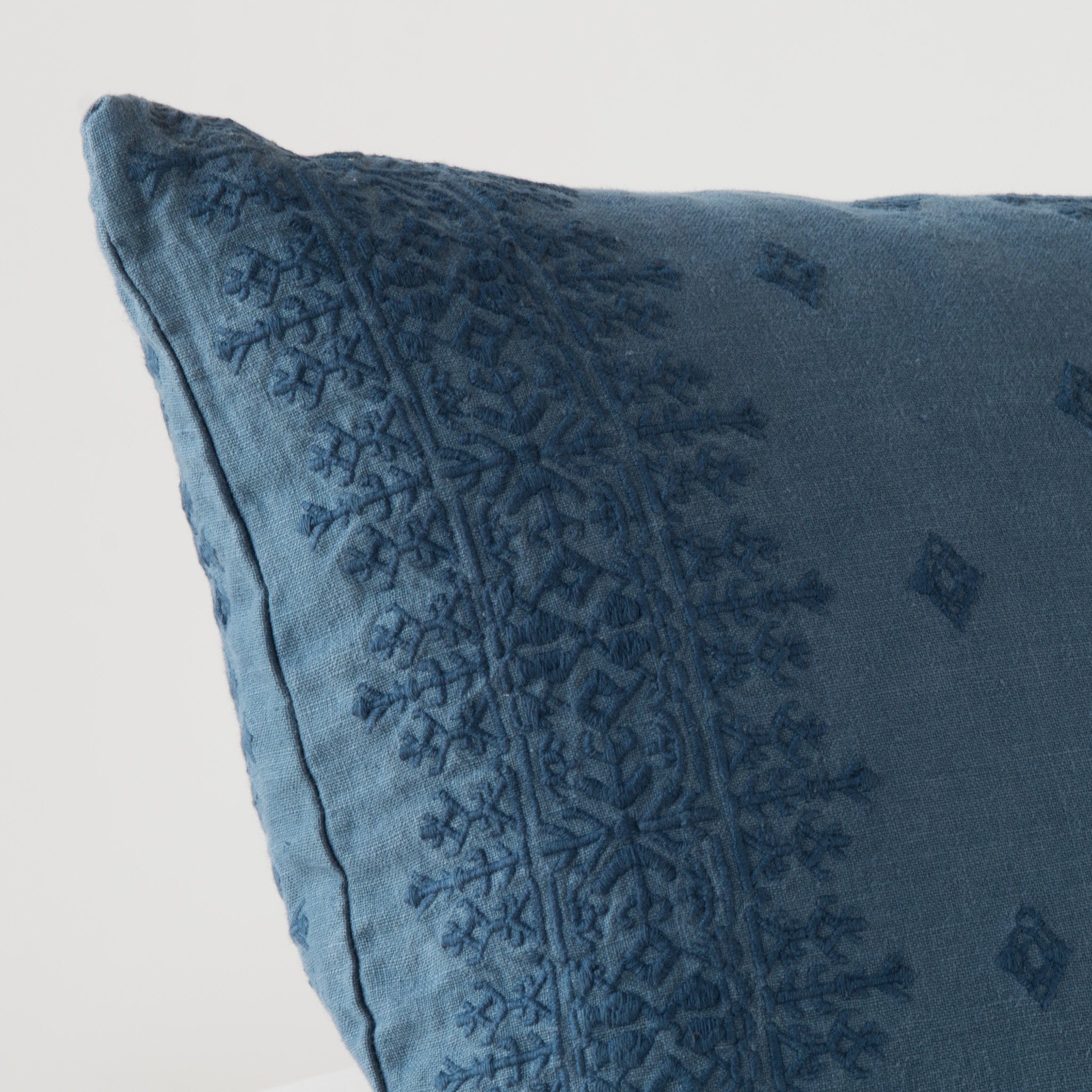 Midnight: Close-up of pillow corner, showcasing the embroidery pattern detail.