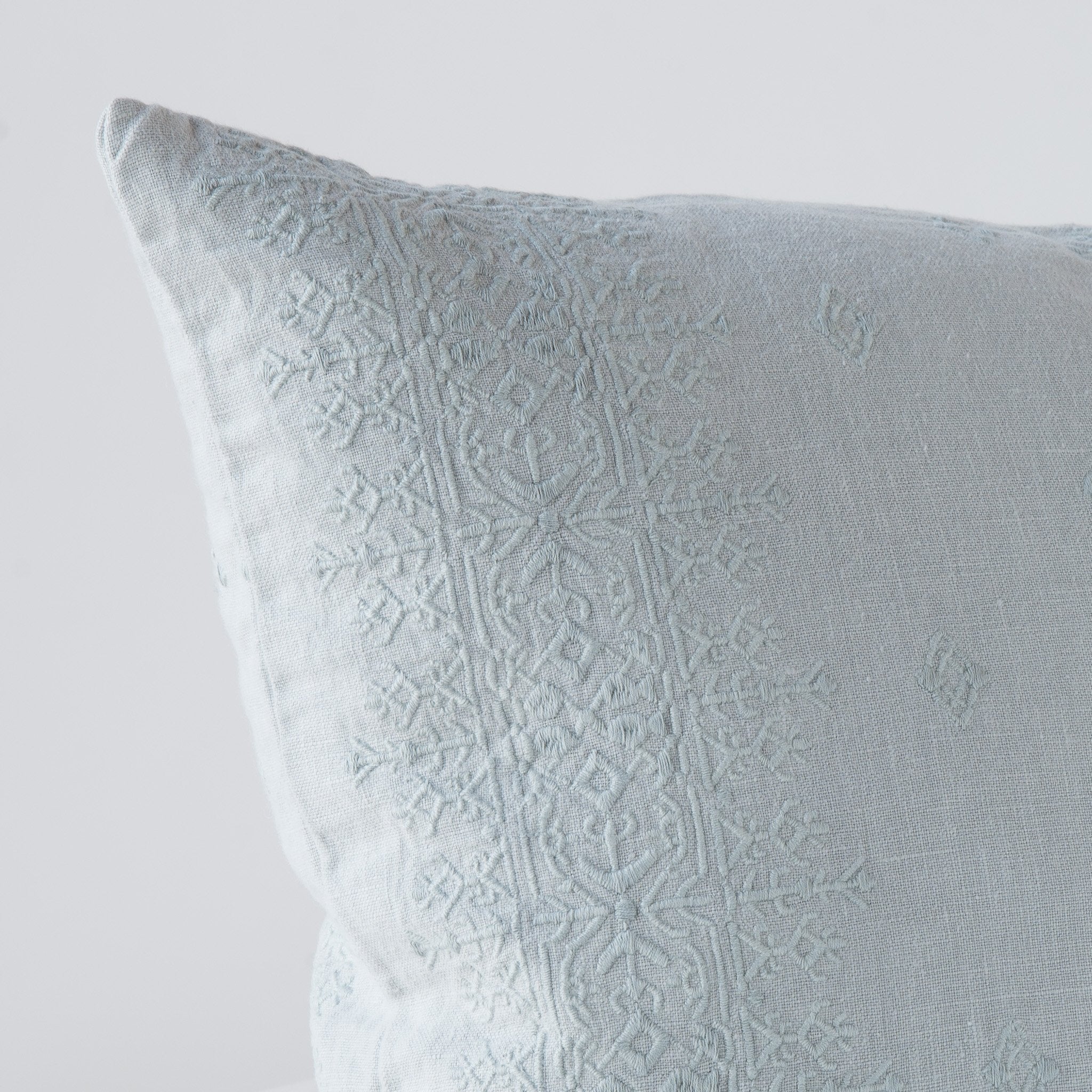Mineral: Close-up of pillow corner, showcasing the embroidery pattern detail.