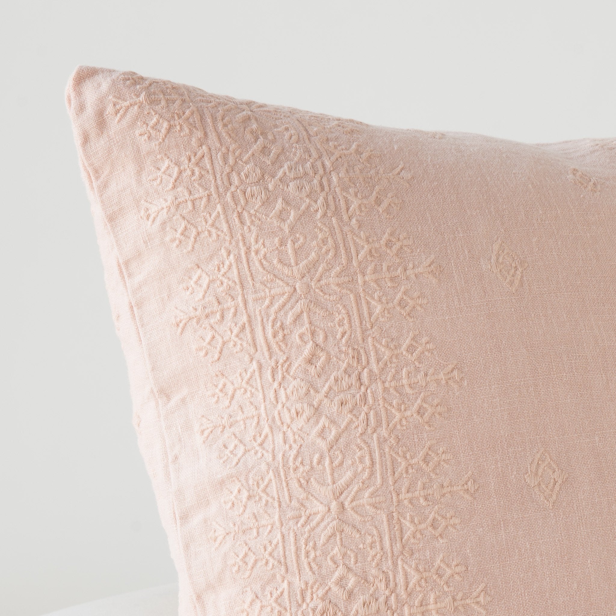 Rouge: Close-up of pillow corner, showcasing the embroidery pattern detail.
