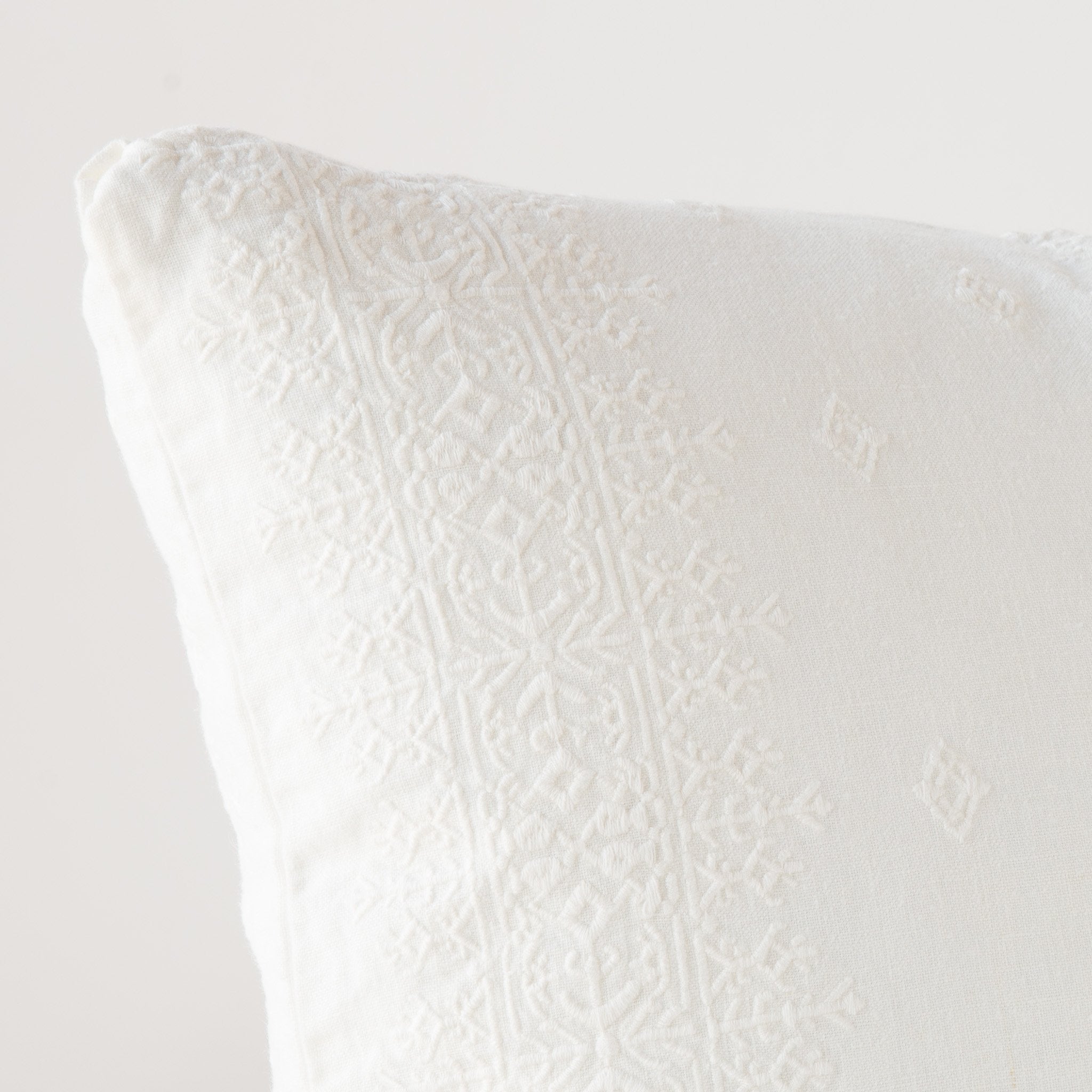 Winter White: Close-up of pillow corner, showcasing the embroidery pattern detail.