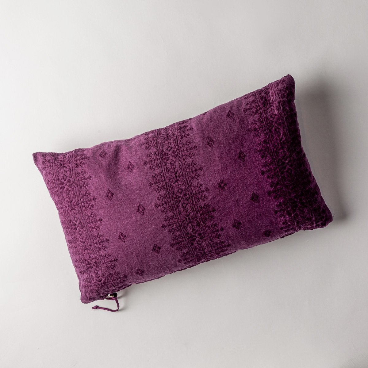 Fig: embroidered midweight linen 15x24 pilow overhead on a white background. 