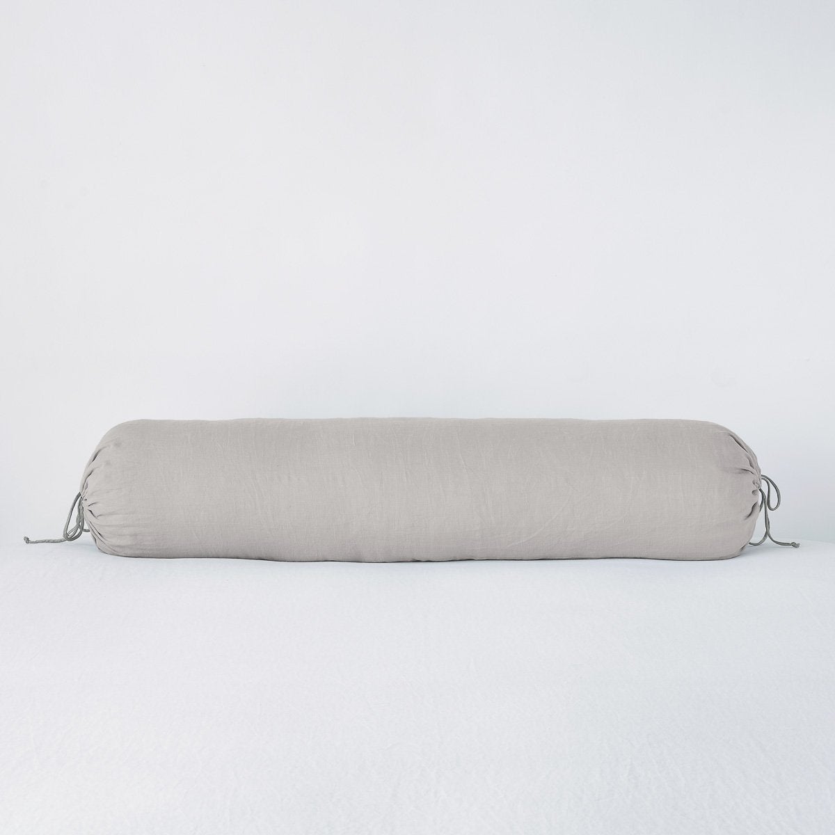 : Linen bolster in fog against a plain background.