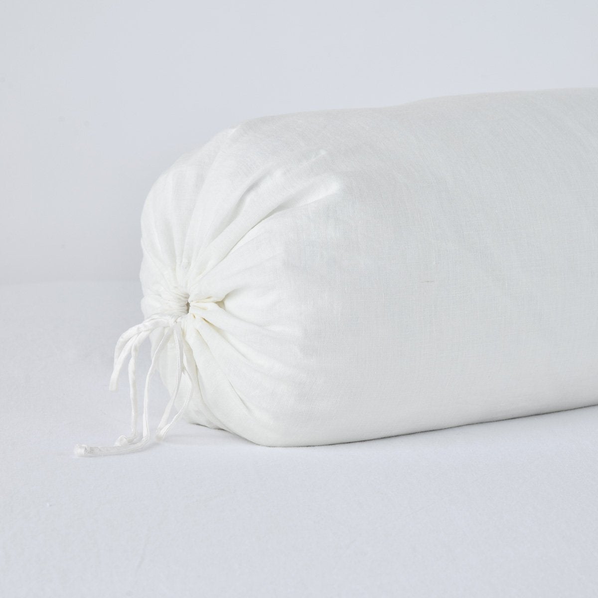 Winter White: Close-up bolster end detail, angled view to show gathered closure and satin ties.