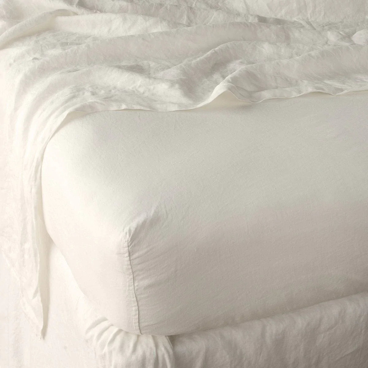 Parchment: close up of fitted sheet with matching rumpled flat sheet - corner view.
