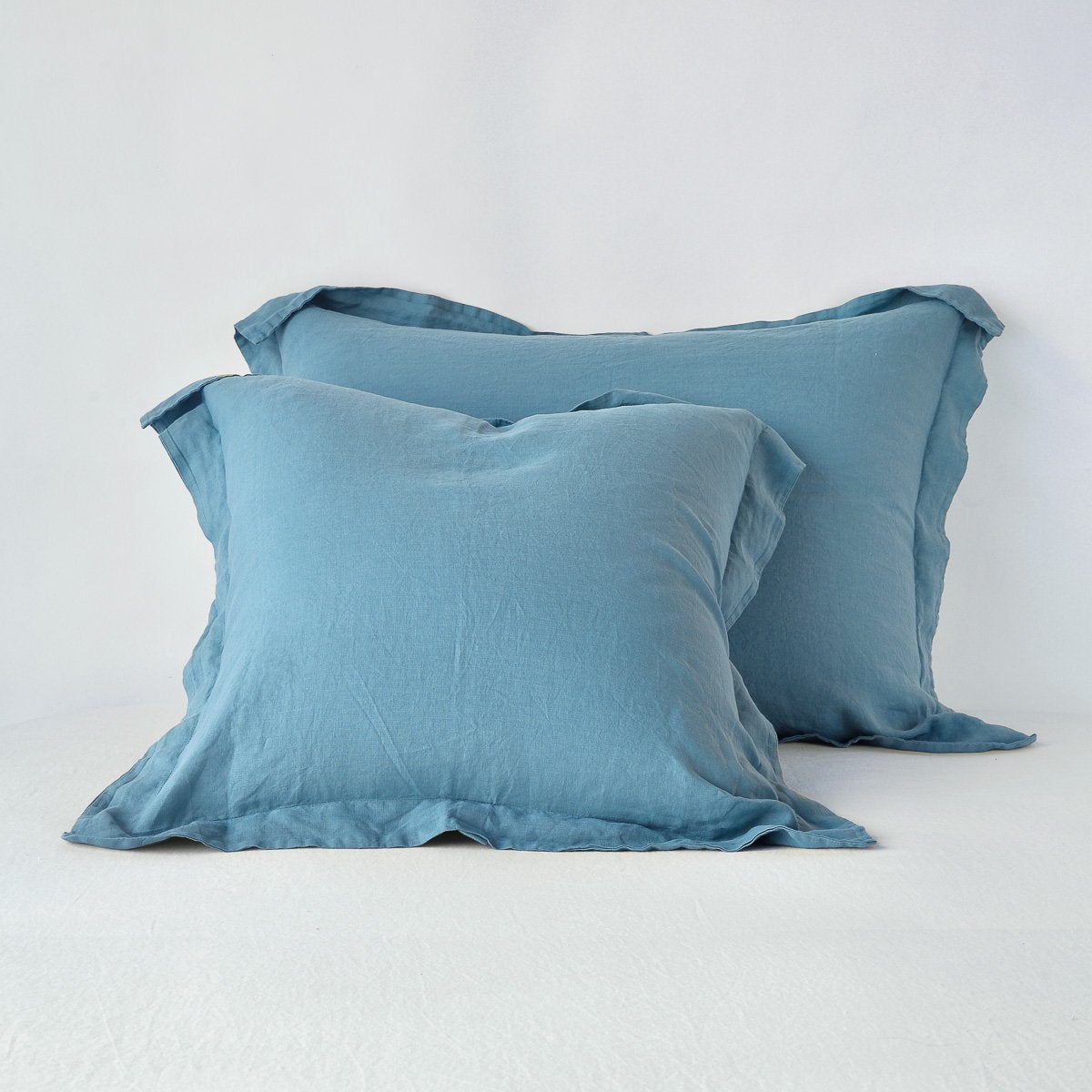 [allvariants]: Linen shams in cenote, leaning upright against a plain background.
