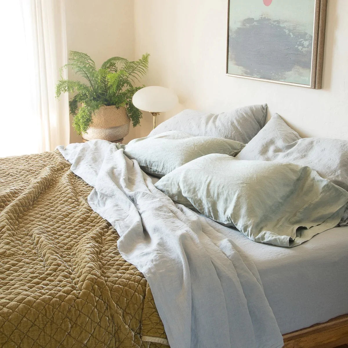 [allvariants]: Soft linen sheeting in cloud, layered with contrasting textures of silk charmeuse and rich gold tones of quilted silk velvet. - cropped three-quarter view.