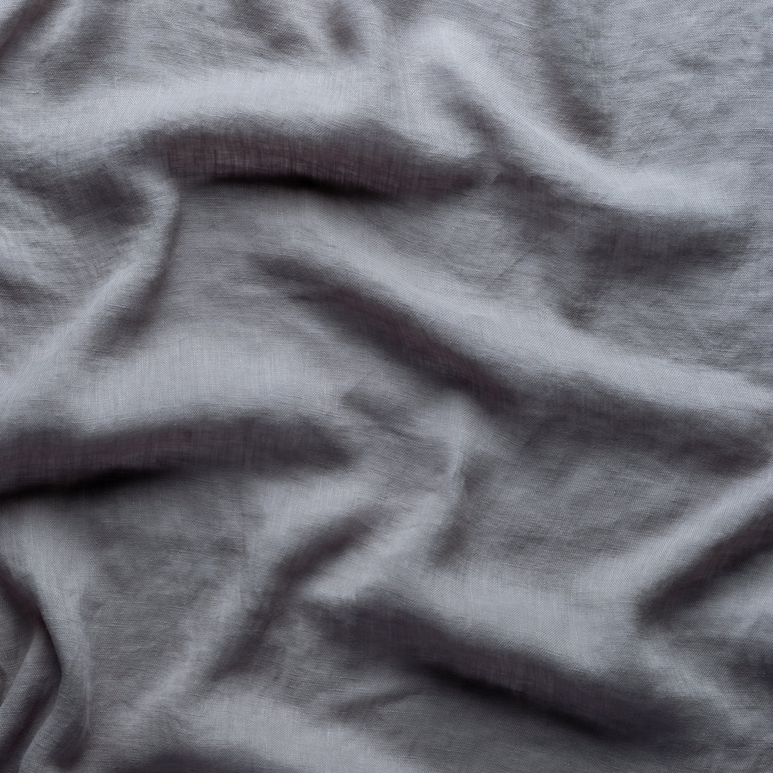 Moonlight: A close up of linen whisper, our lightweight linen gauze, in moonlight, a saturated, cool, mid-dark grey tone. 