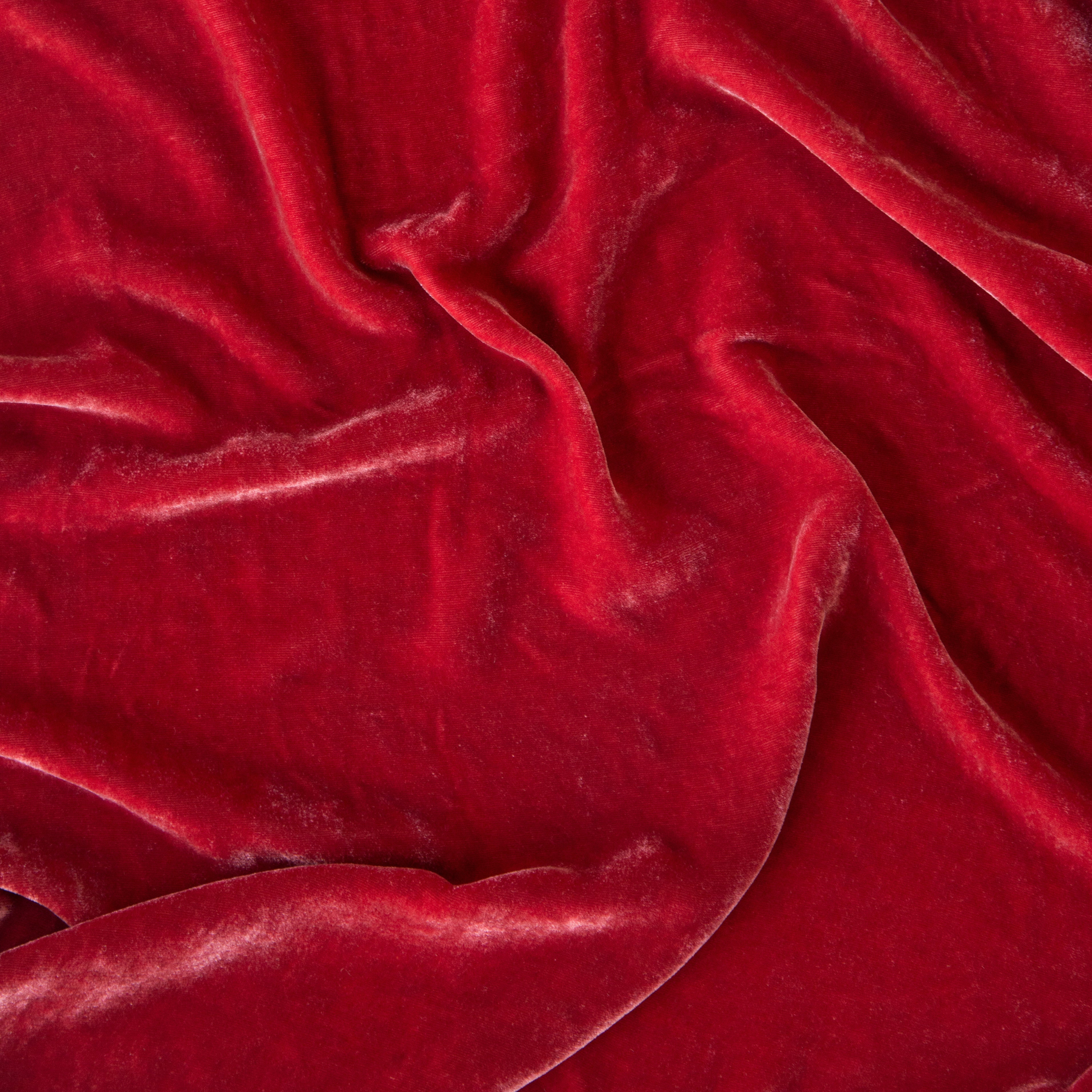 Poppy: A close up of silk velvet in poppy, a vibrant coral pink. 
