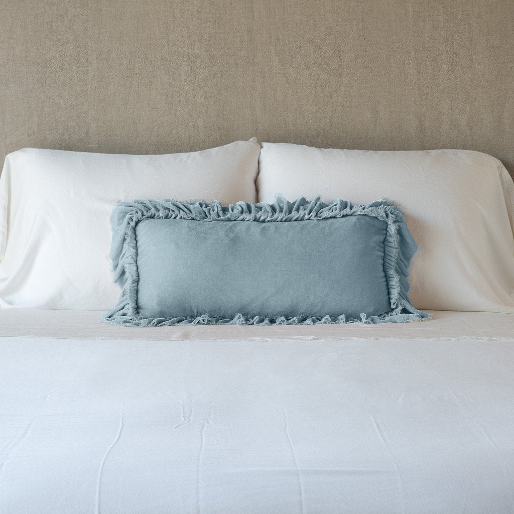 Cloud: pillow on a white bed - cropped end of bed view.