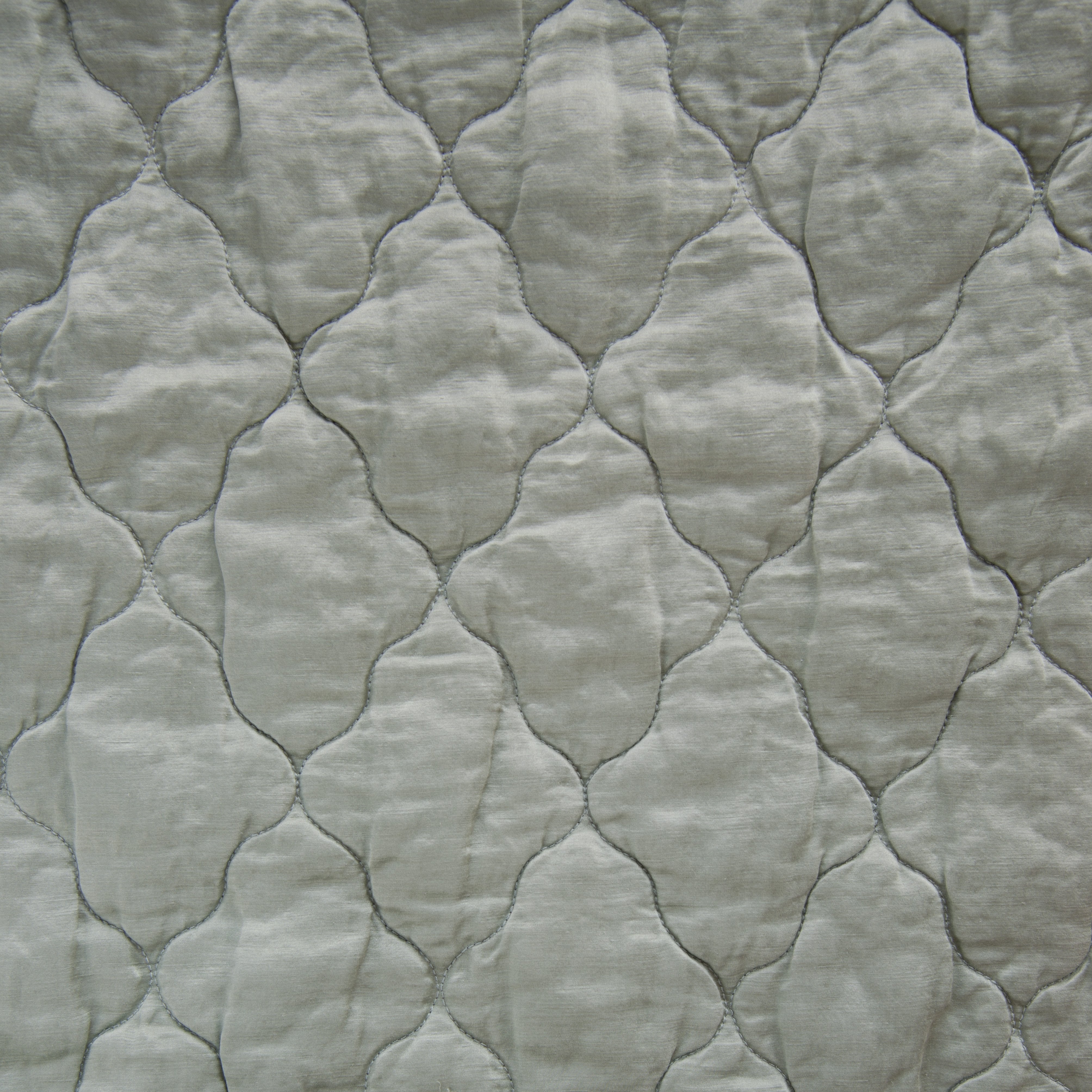 Mineral: Close-up of Luna silk charmeuse quilting in mineral, a soothing seafoam blue with subtle grey-green undertones. 