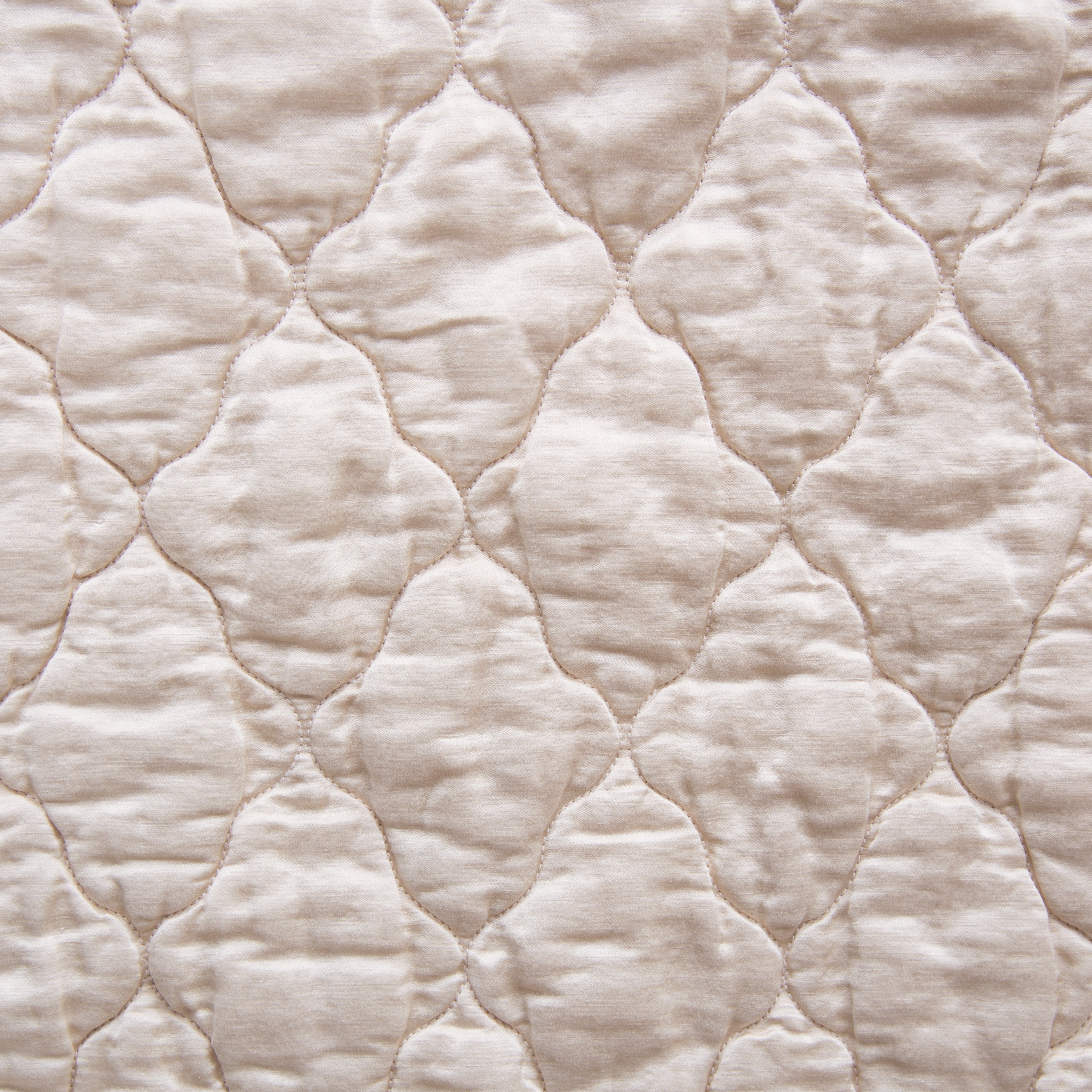 Pearl: Close-up of Luna silk charmeuse quilting in pearl, a nude-like, soft rose pink tone. 