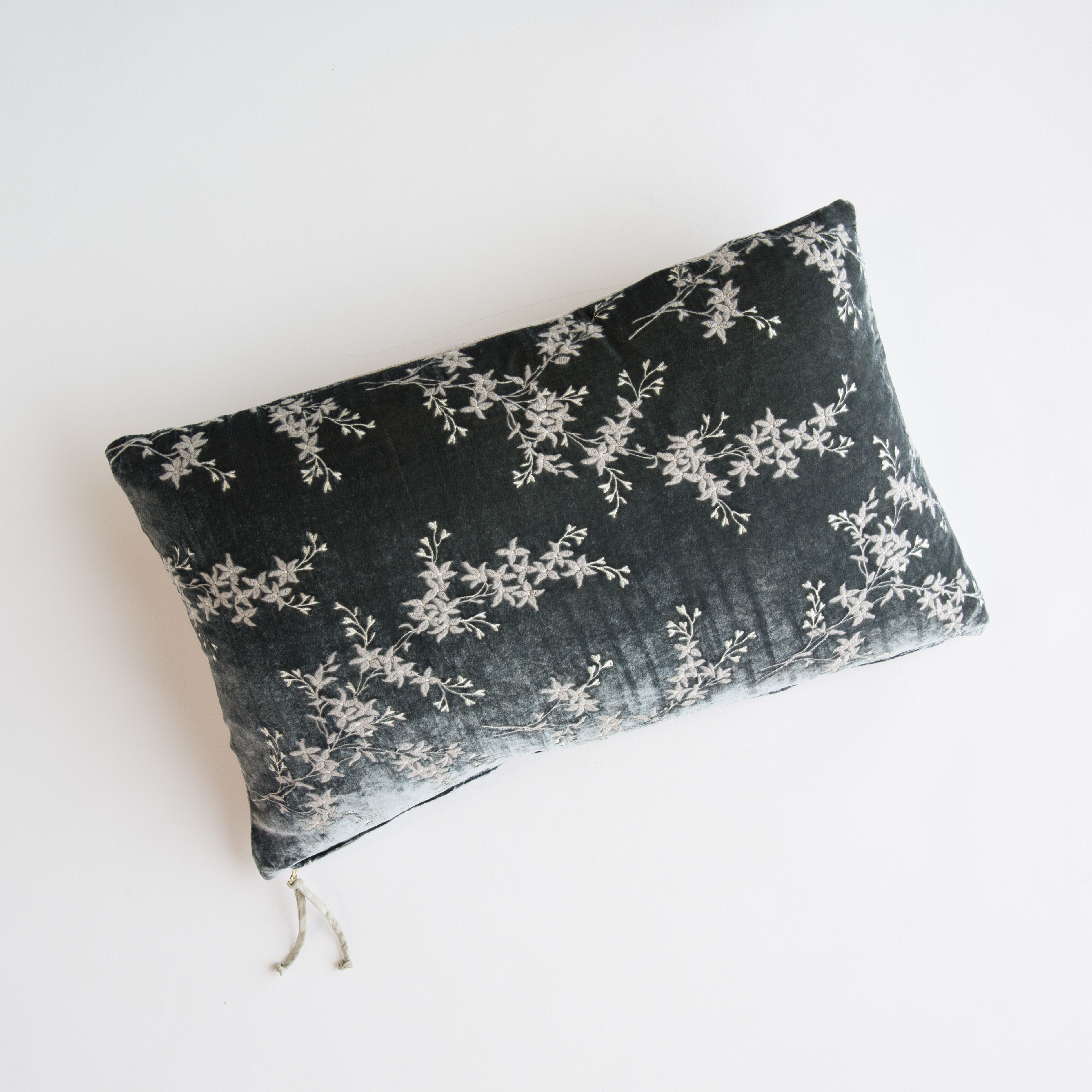 Fog: overhead of 15x24 embroidered silk velvet pillow against a white background