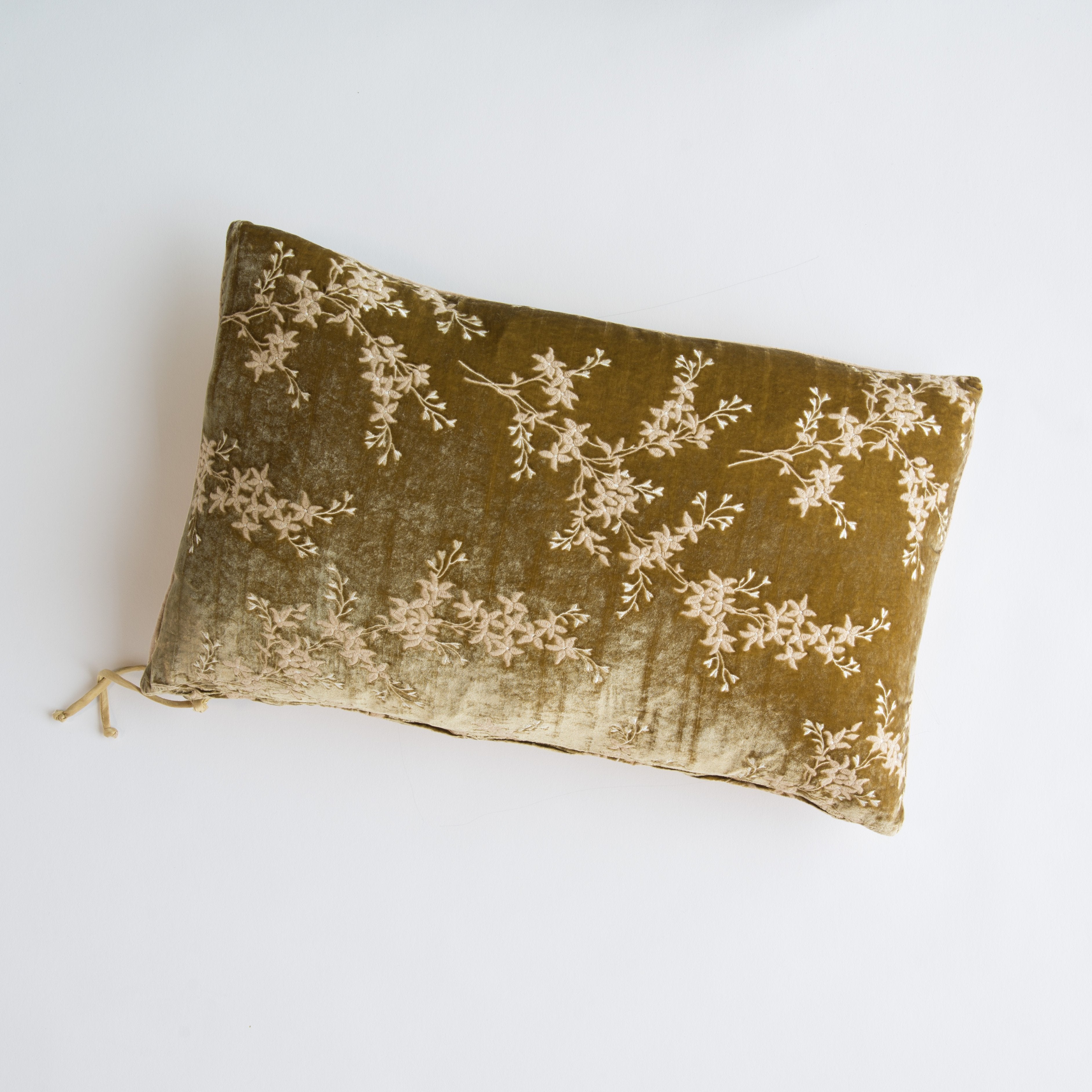 Honeycomb: overhead of 15x24 embroidered silk velvet pillow against a white background