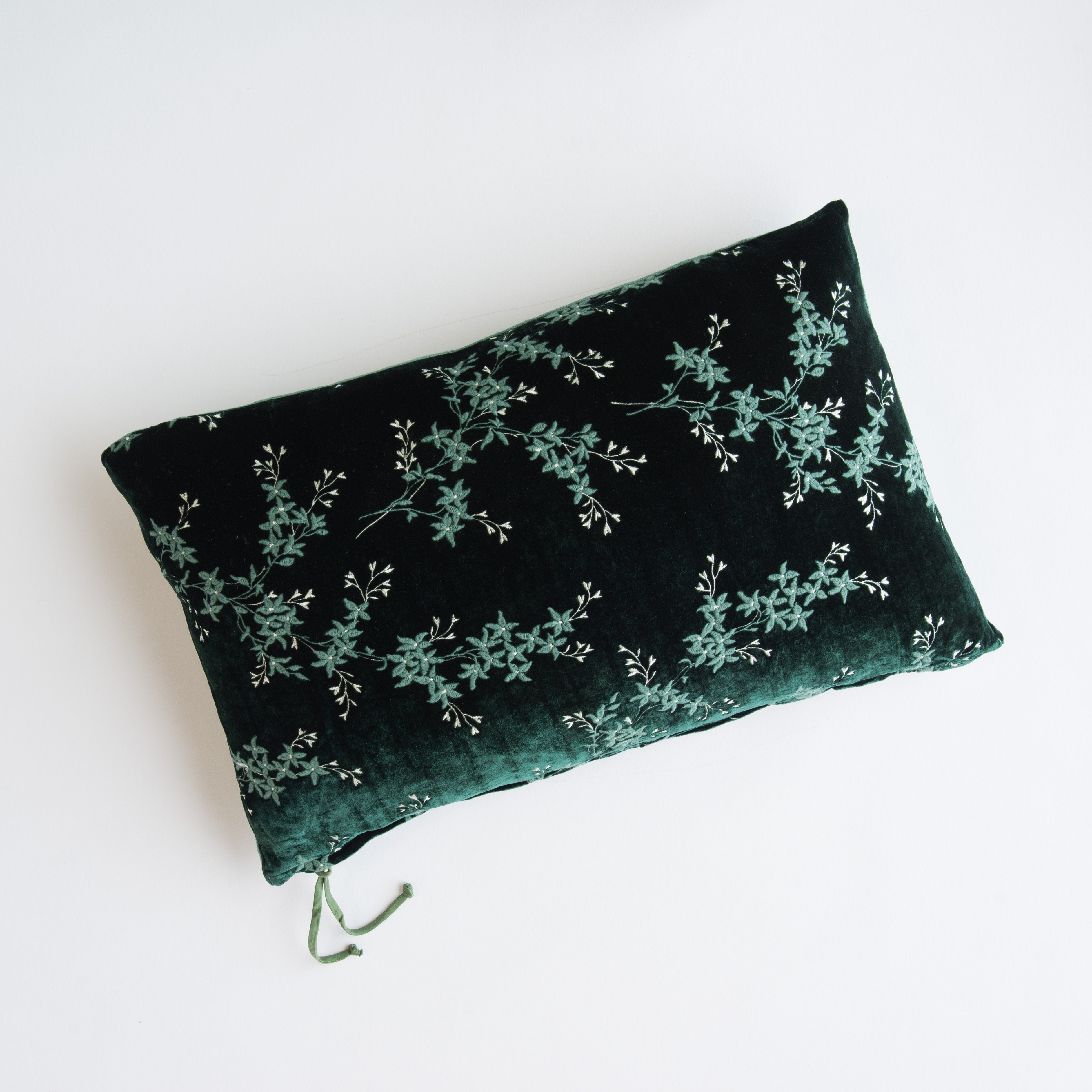 Jade: overhead of 15x24 embroidered silk velvet pillow against a white background