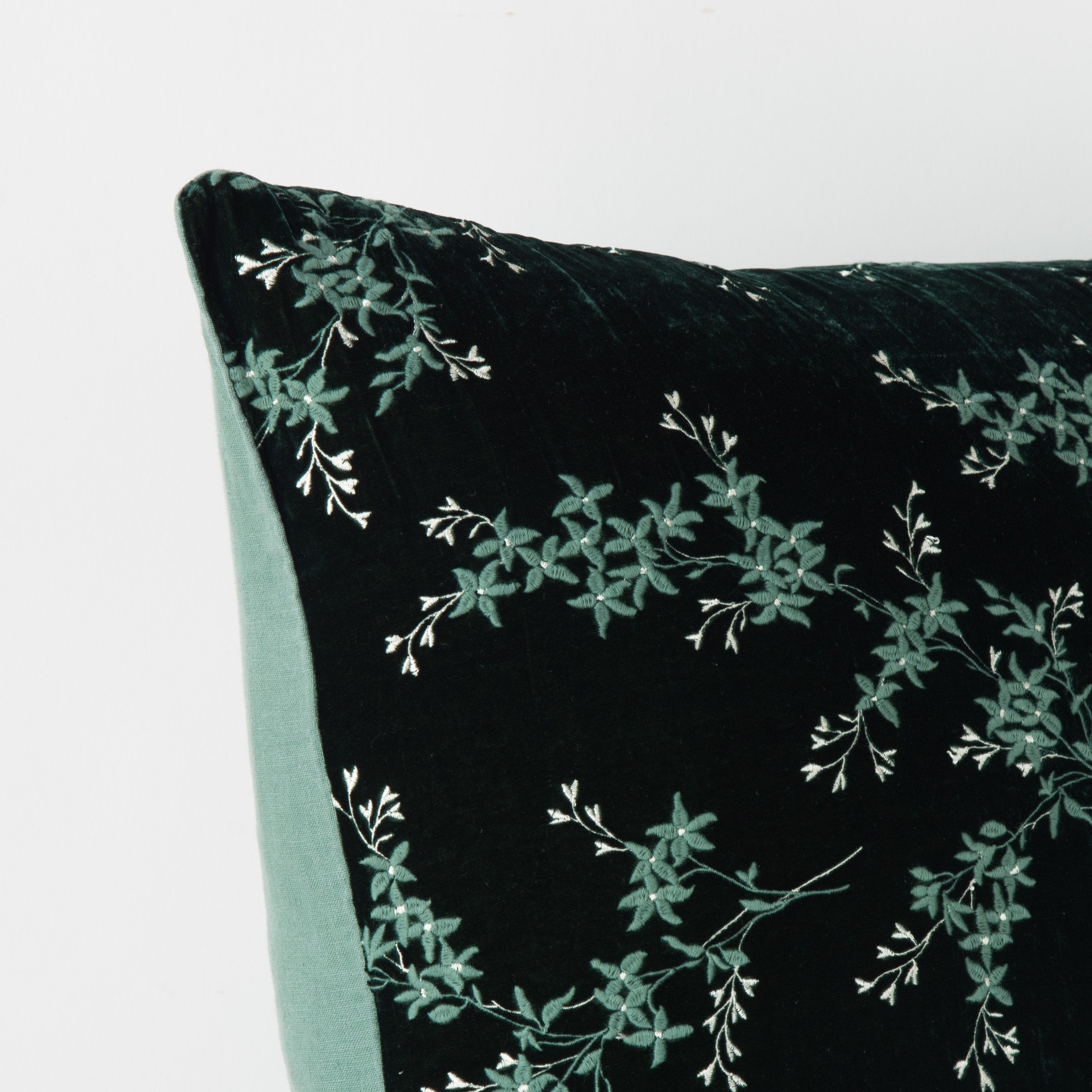 : Corner detail close-up of Lynette sham, highlighting two-tone embroidery and linen back - jade.