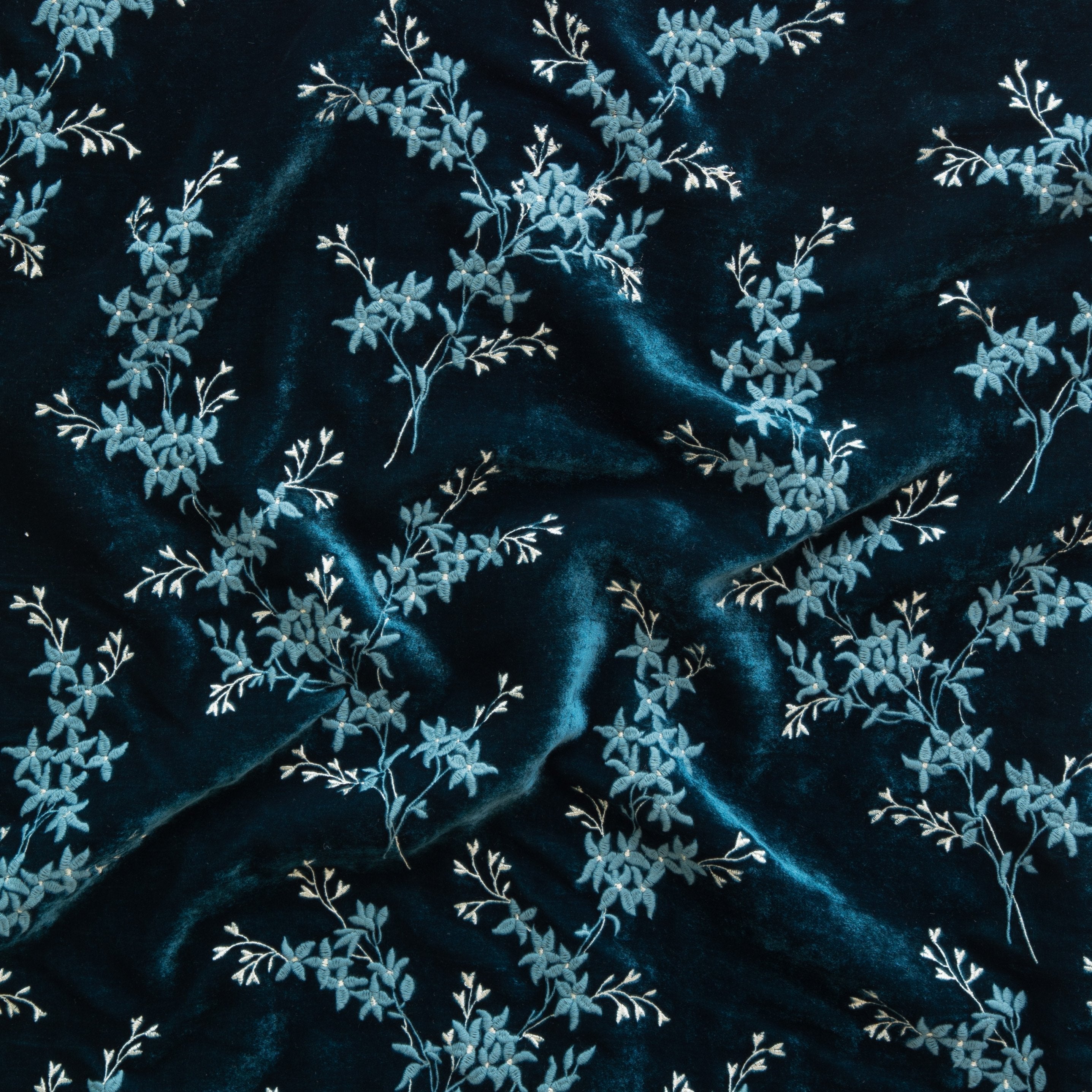 Cenote: A close up of Lynette embroidered silk velvet, in cenote, a vibrant, ocean-inspired blue-green.
