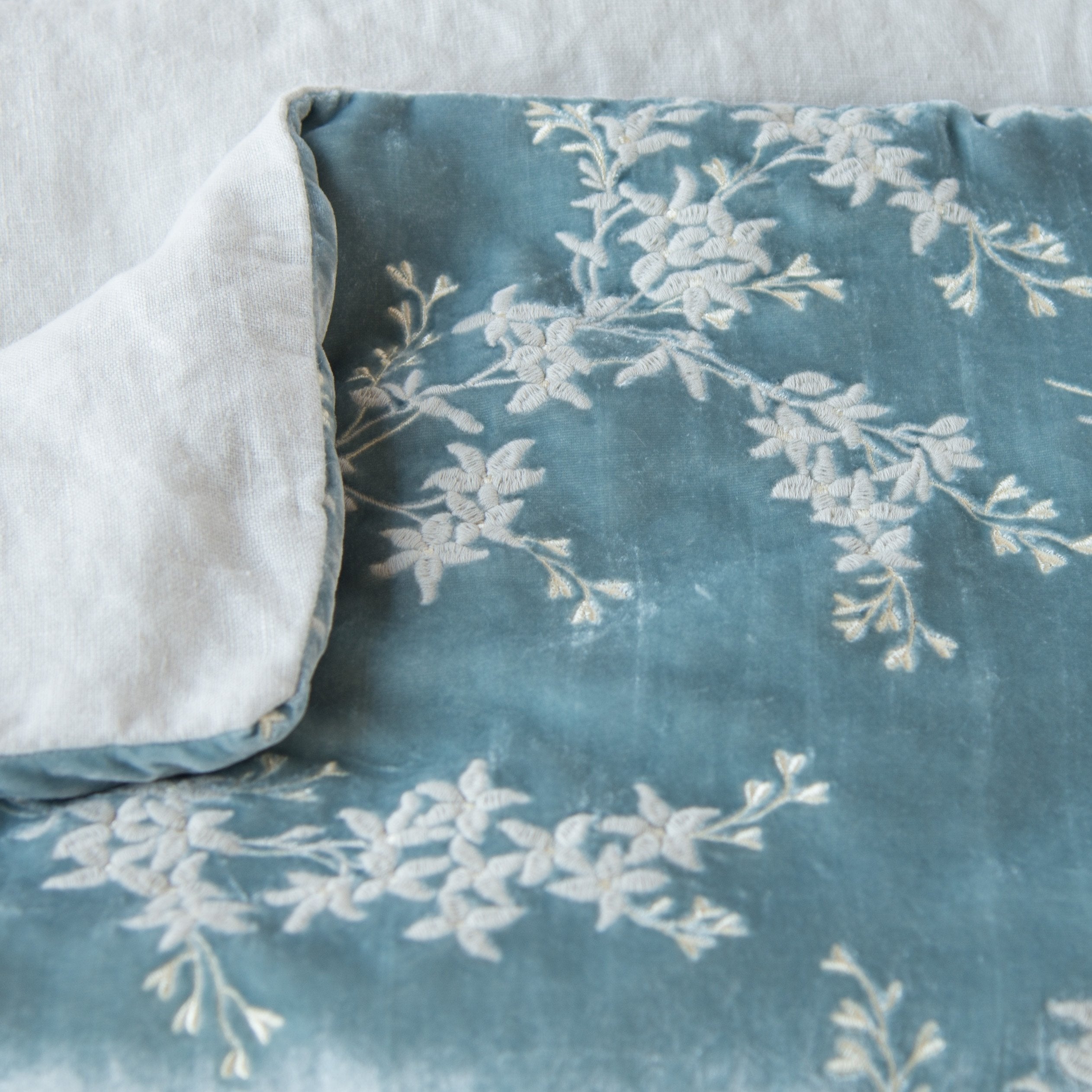 Cloud: Close up of blanket, with a corner turned back to showcase the linen back - overhead view.