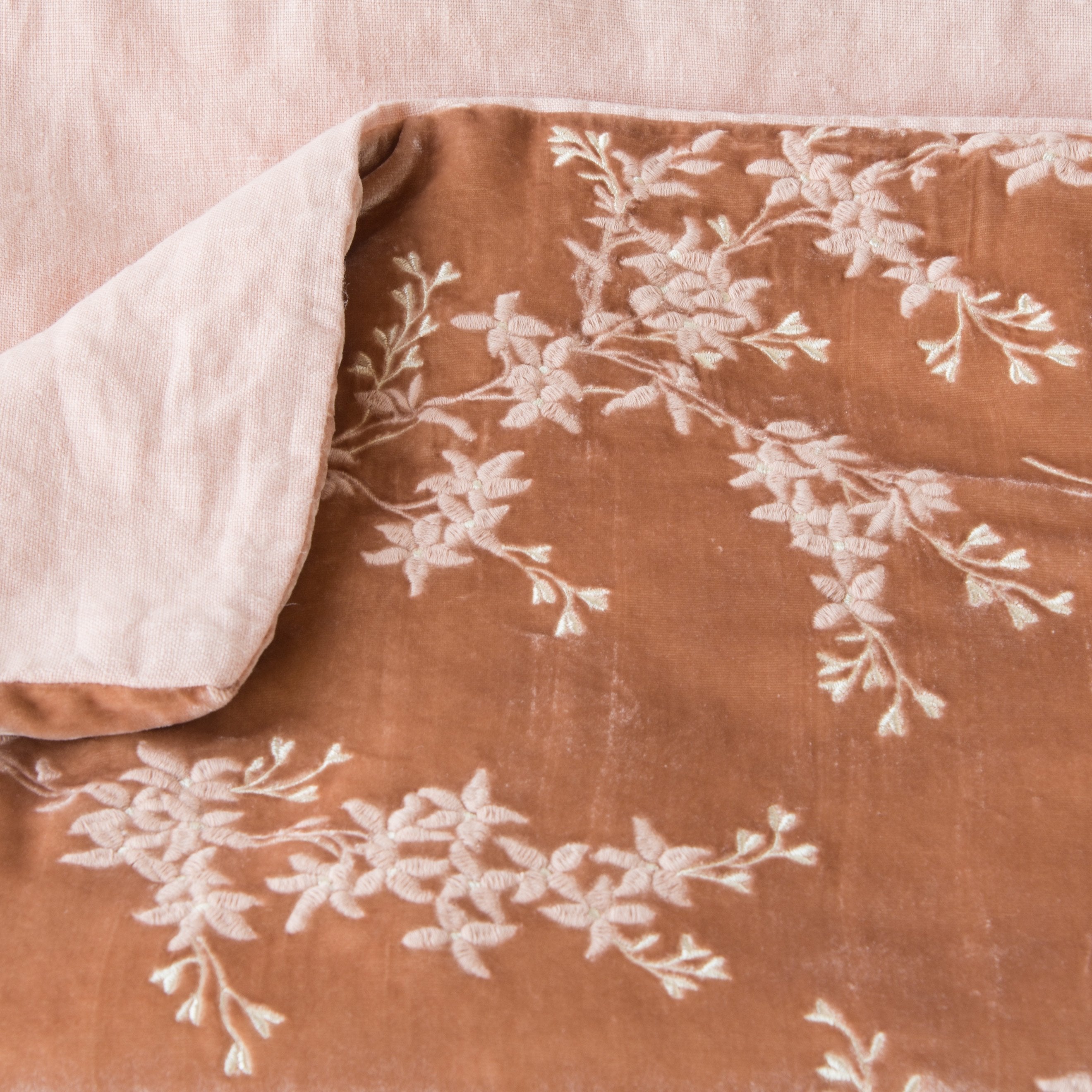 Rouge: Close up of blanket, with a corner turned back to showcase the linen back - overhead view.