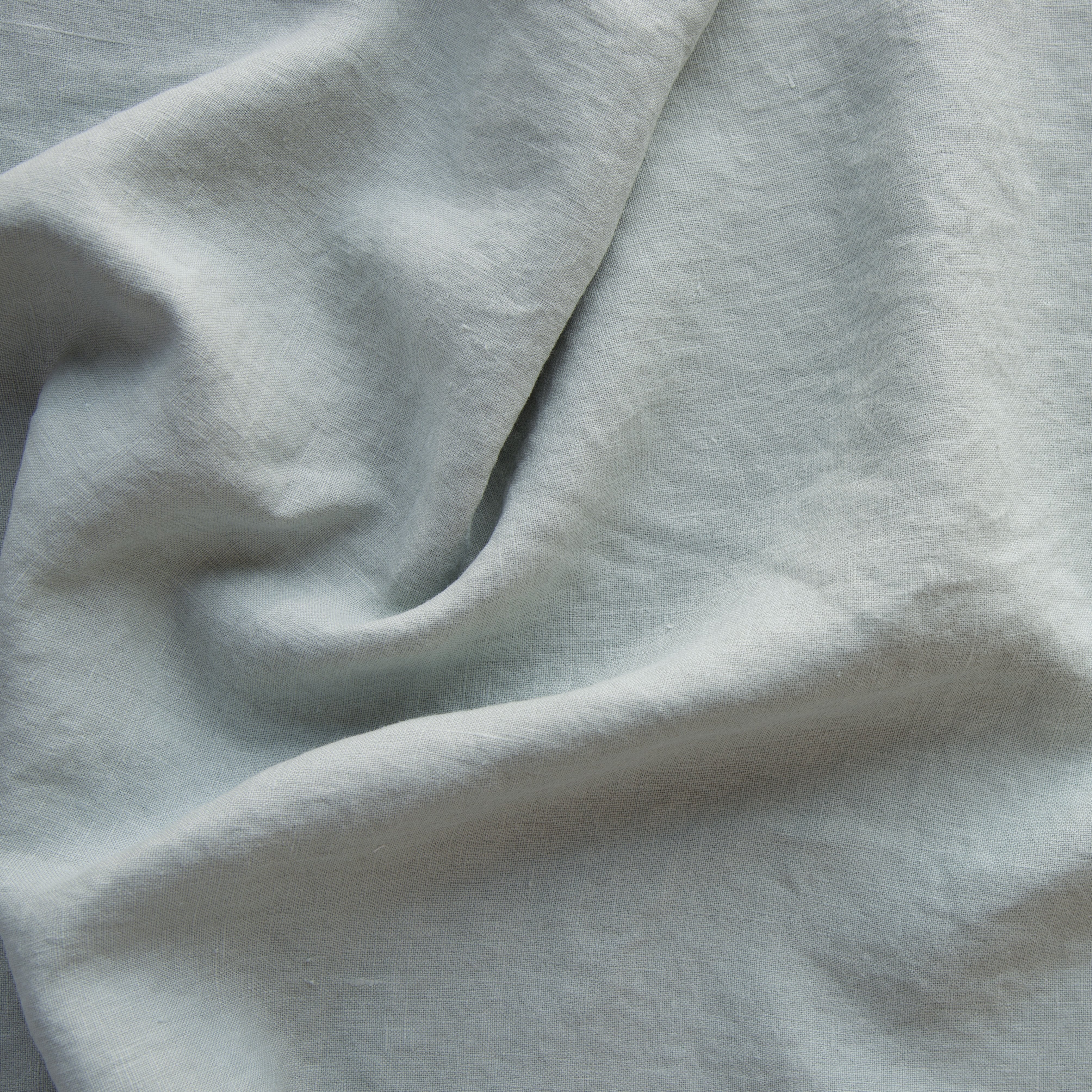 Eucalyptus: A close up of midweight linen in eucalyptus, a soft light green. 