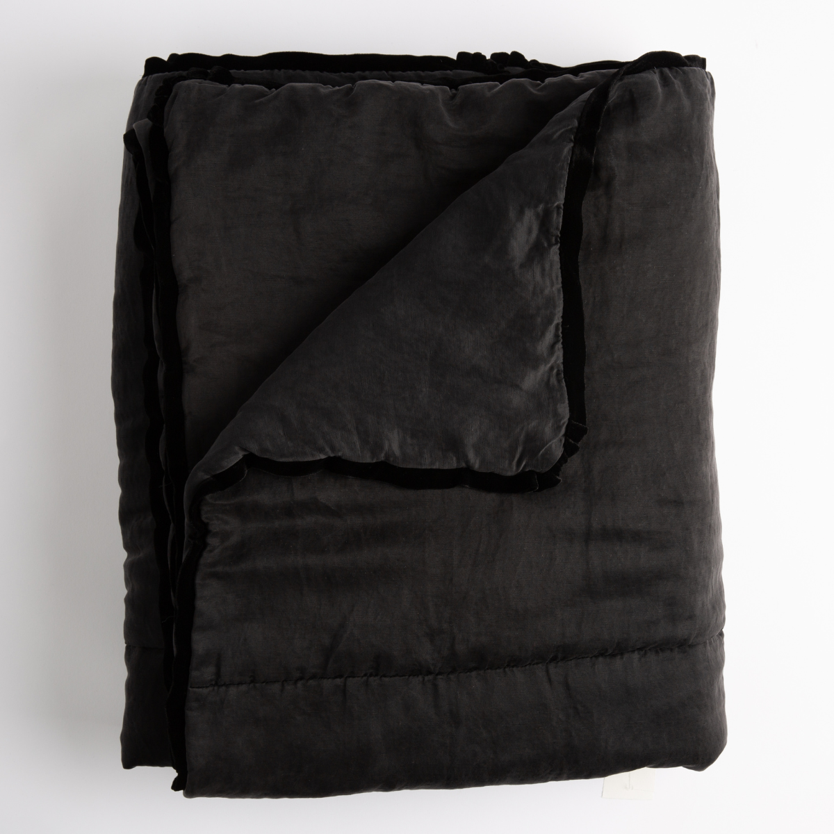Corvino: folded bed blanket with corner turned down to show silk velvet trim. 