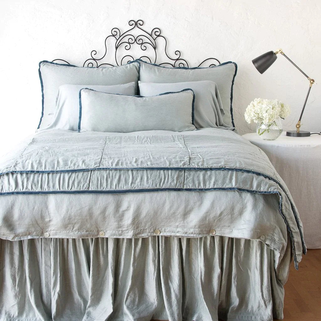 : Mineral 16x36 pillow on monochromatic bed with other pieces from the Paloma collection. 