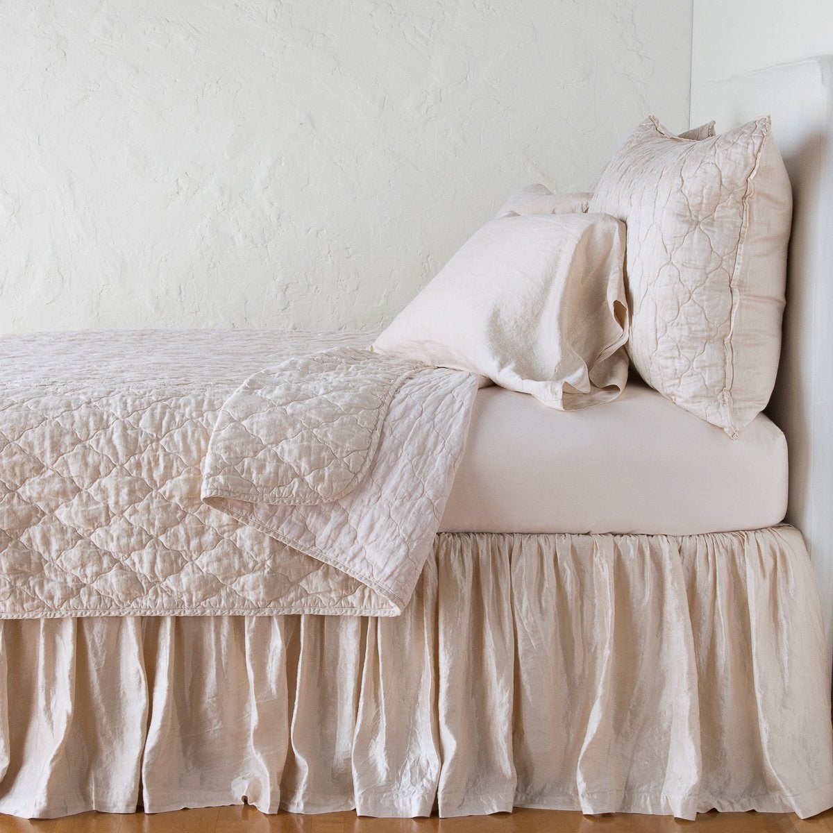 Pearl: sleeping pillows on a monochromatic charmeuse bed - side view.