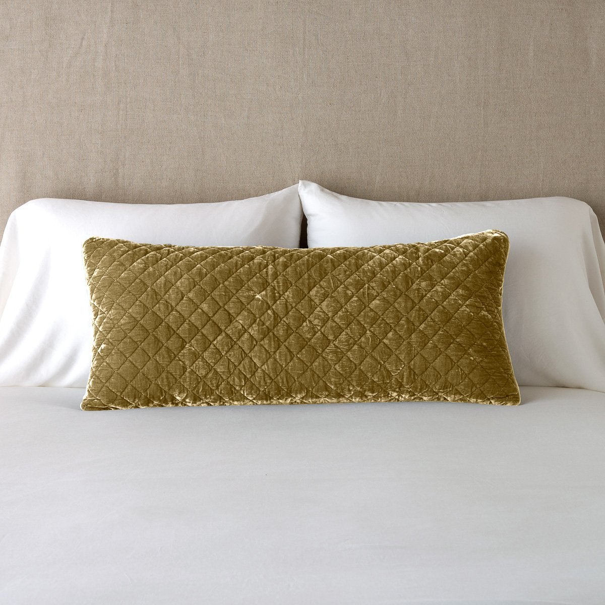 Honeycomb: 16x36 pillow leaning upright against white sleeping pillows and a neutral headboard.