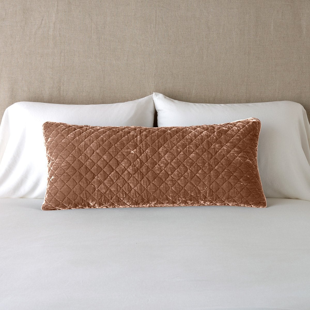 Rouge: 16x36 pillow leaning upright against white sleeping pillows and a neutral headboard.