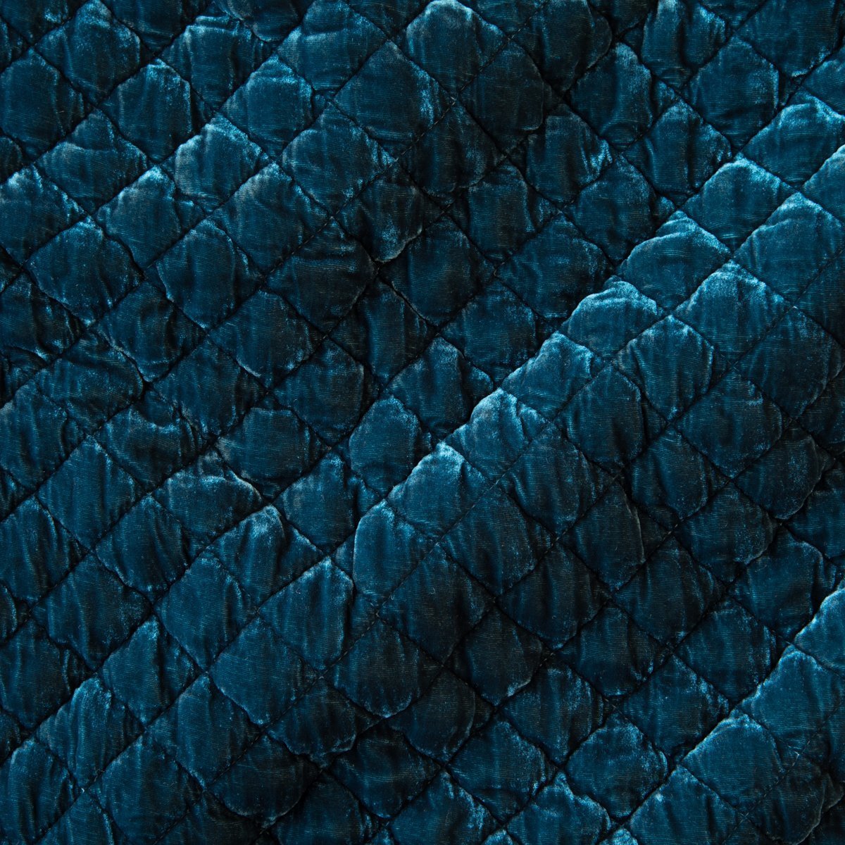 Cenote: Close-up of quilted silk velvet in cenote, a vibrant, ocean-inspired blue-green.