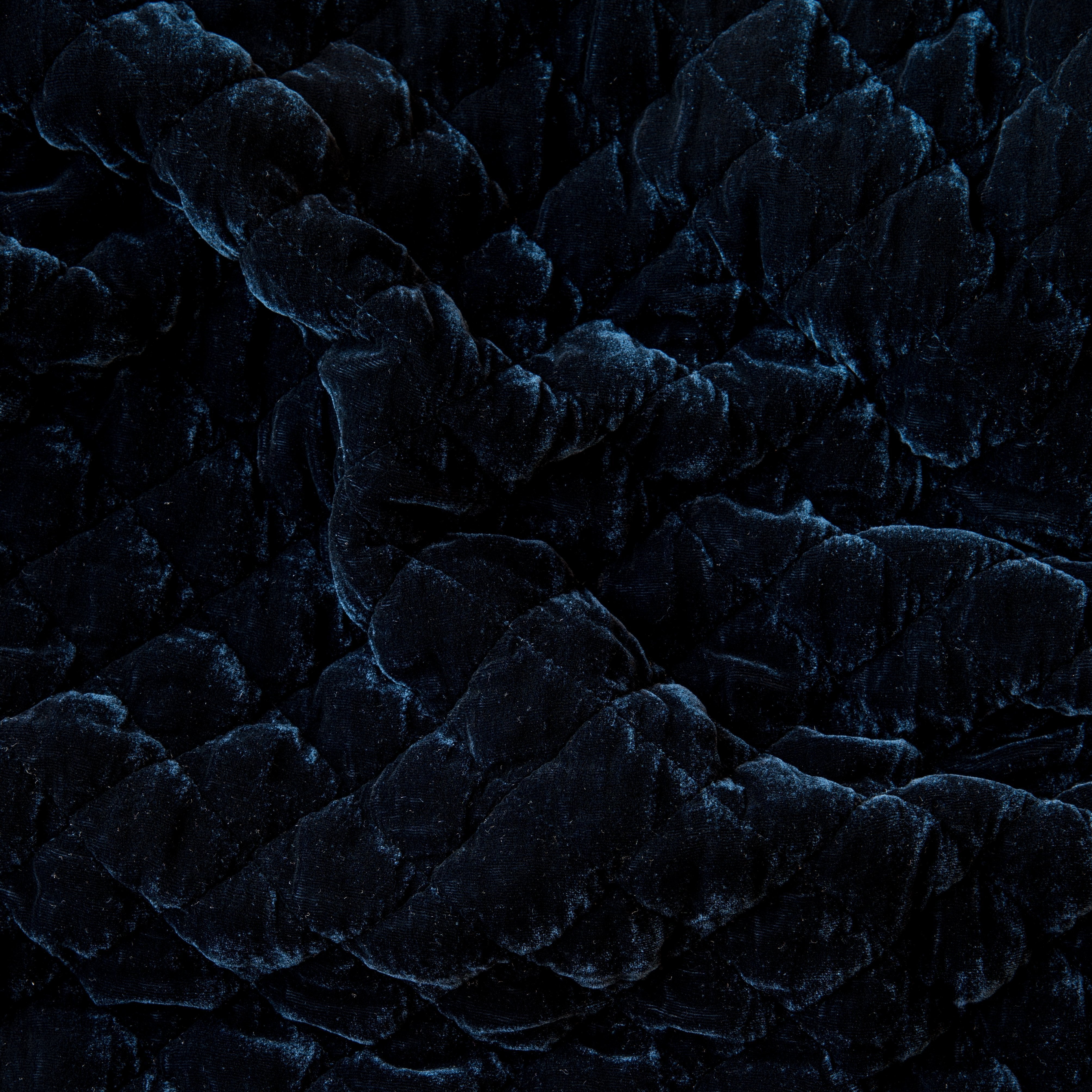 Midnight: Close-up of quilted silk velvet in midnight, a rich indigo tone. 