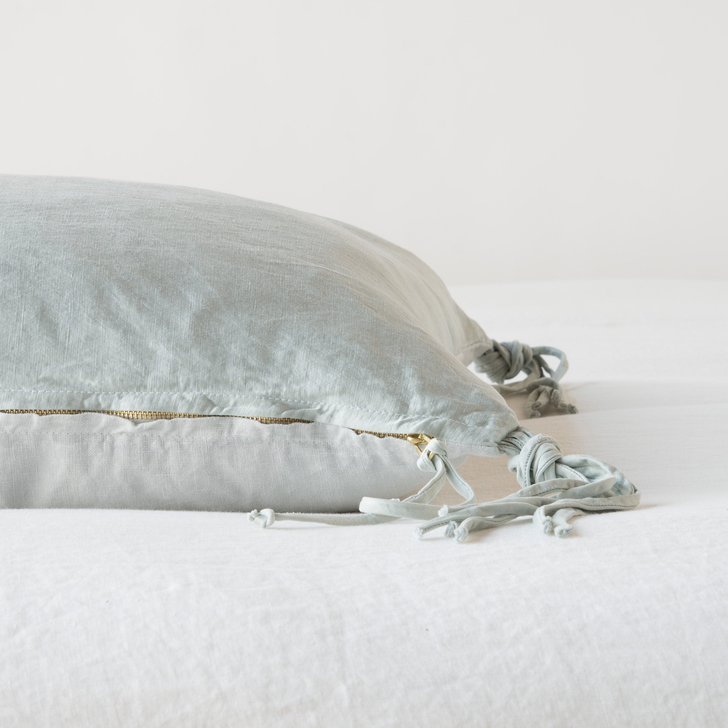 Cloud: Close-up side vew featuring brass zipper with charmeuse pull and linen back.