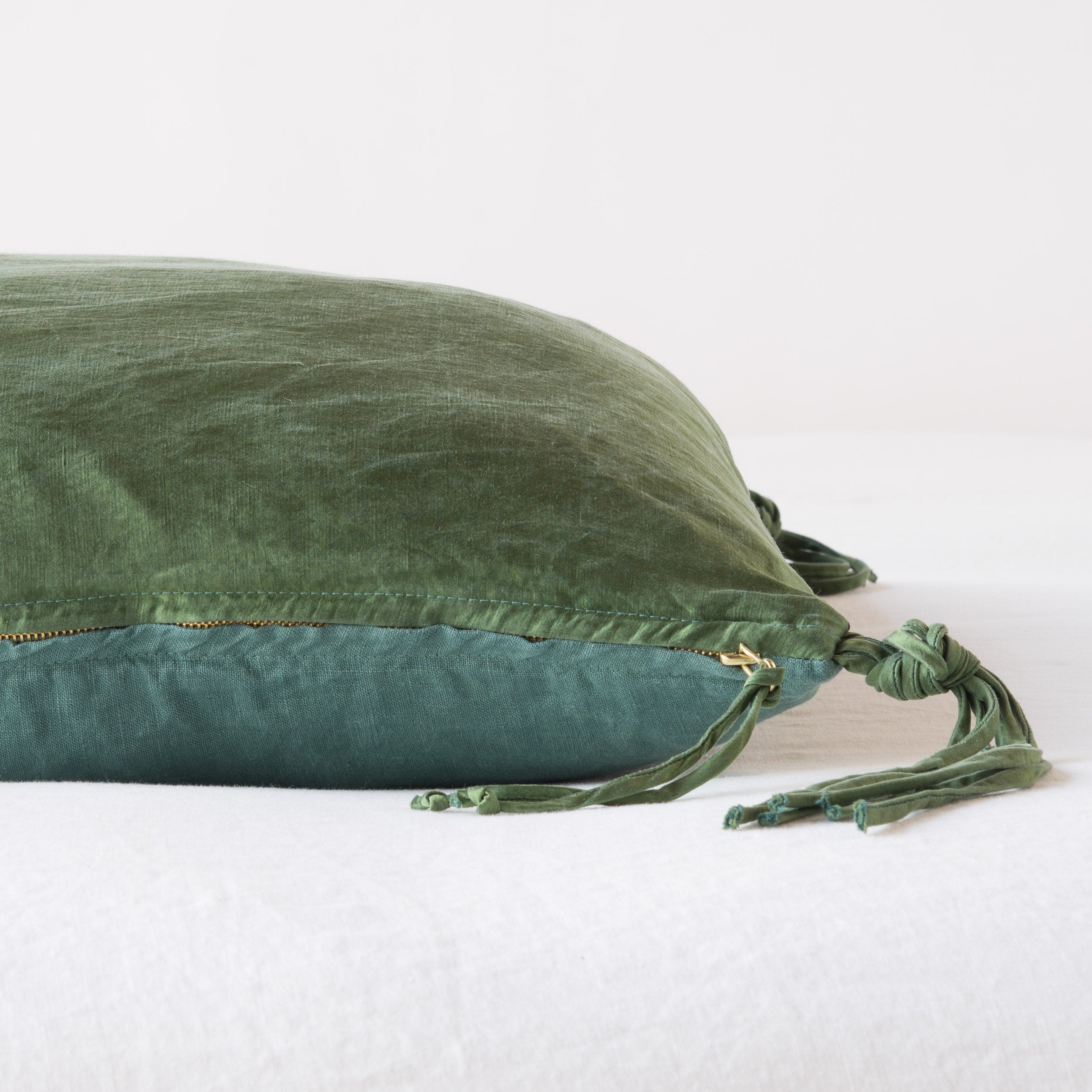 Jade: Close-up side vew featuring brass zipper with charmeuse pull and linen back.