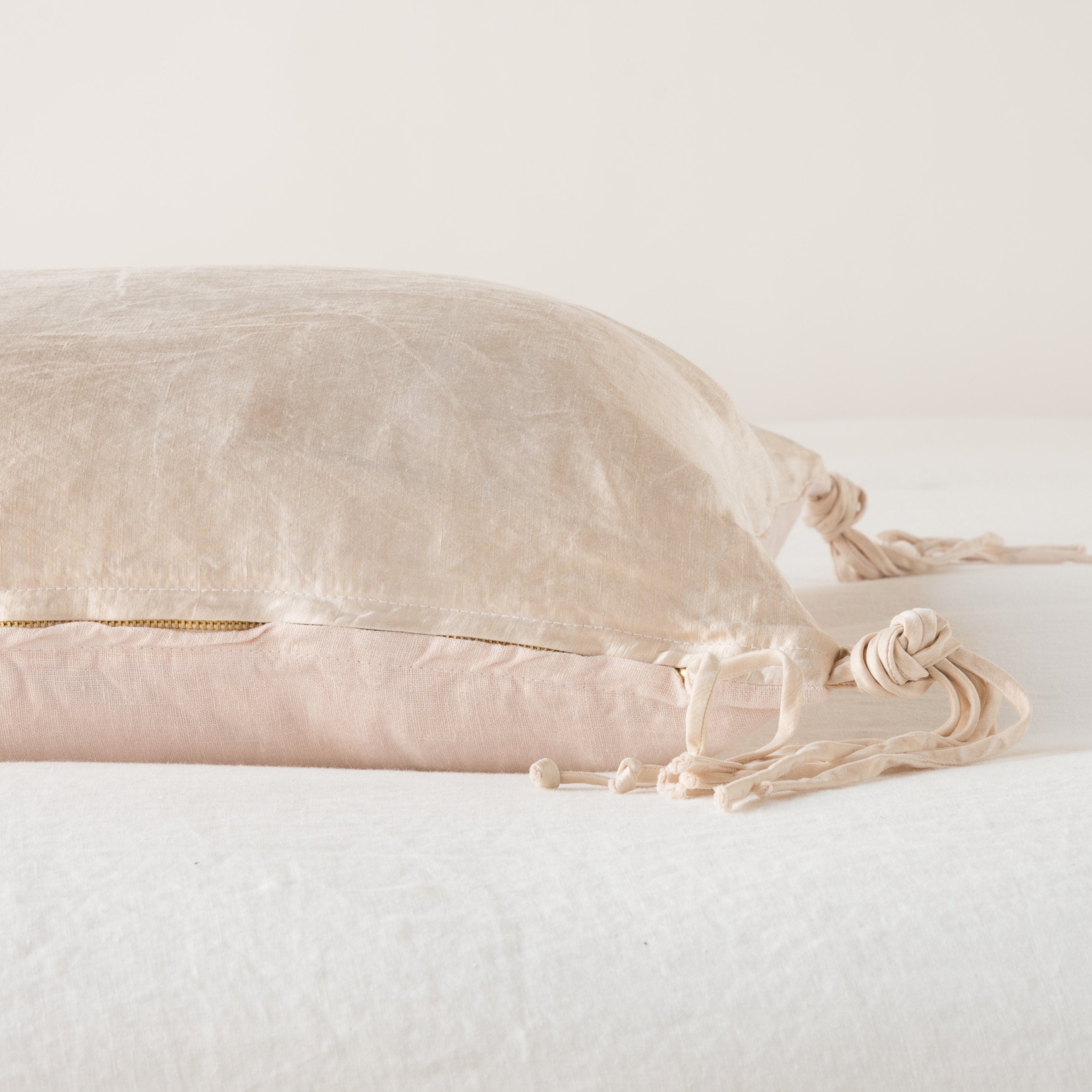 Pearl: Close-up side vew featuring brass zipper with charmeuse pull and linen back.