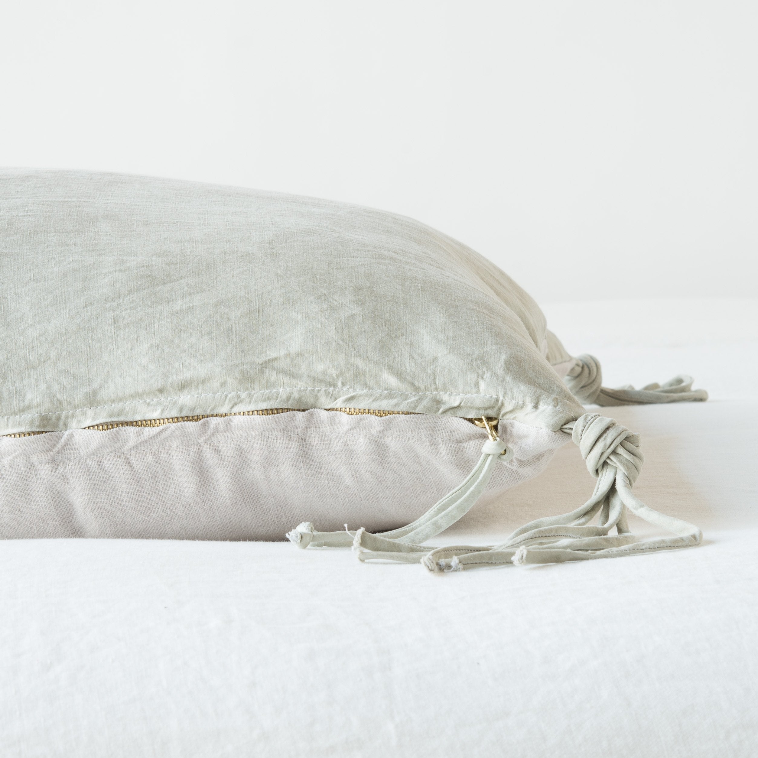 Sterling: Close-up side vew featuring brass zipper with charmeuse pull and linen back.