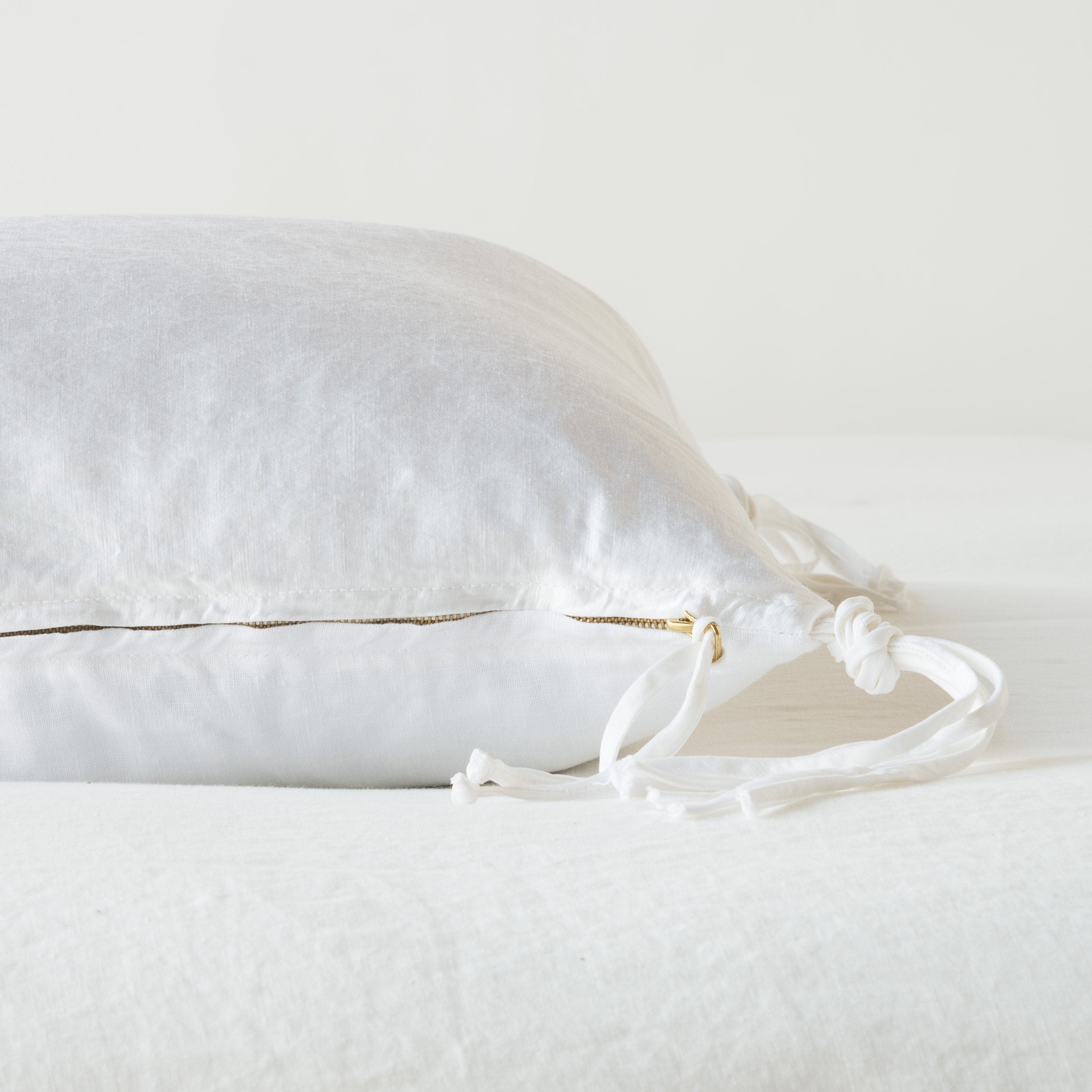 White: Close-up side vew featuring brass zipper with charmeuse pull and linen back.