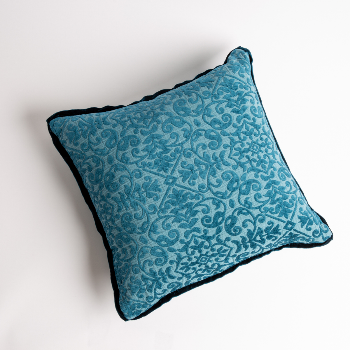 Cenote: cotton chenille jacquard 18x18 pillow shown from overhead to display the pillow's face and silk velvet trim — overhead against a white background.