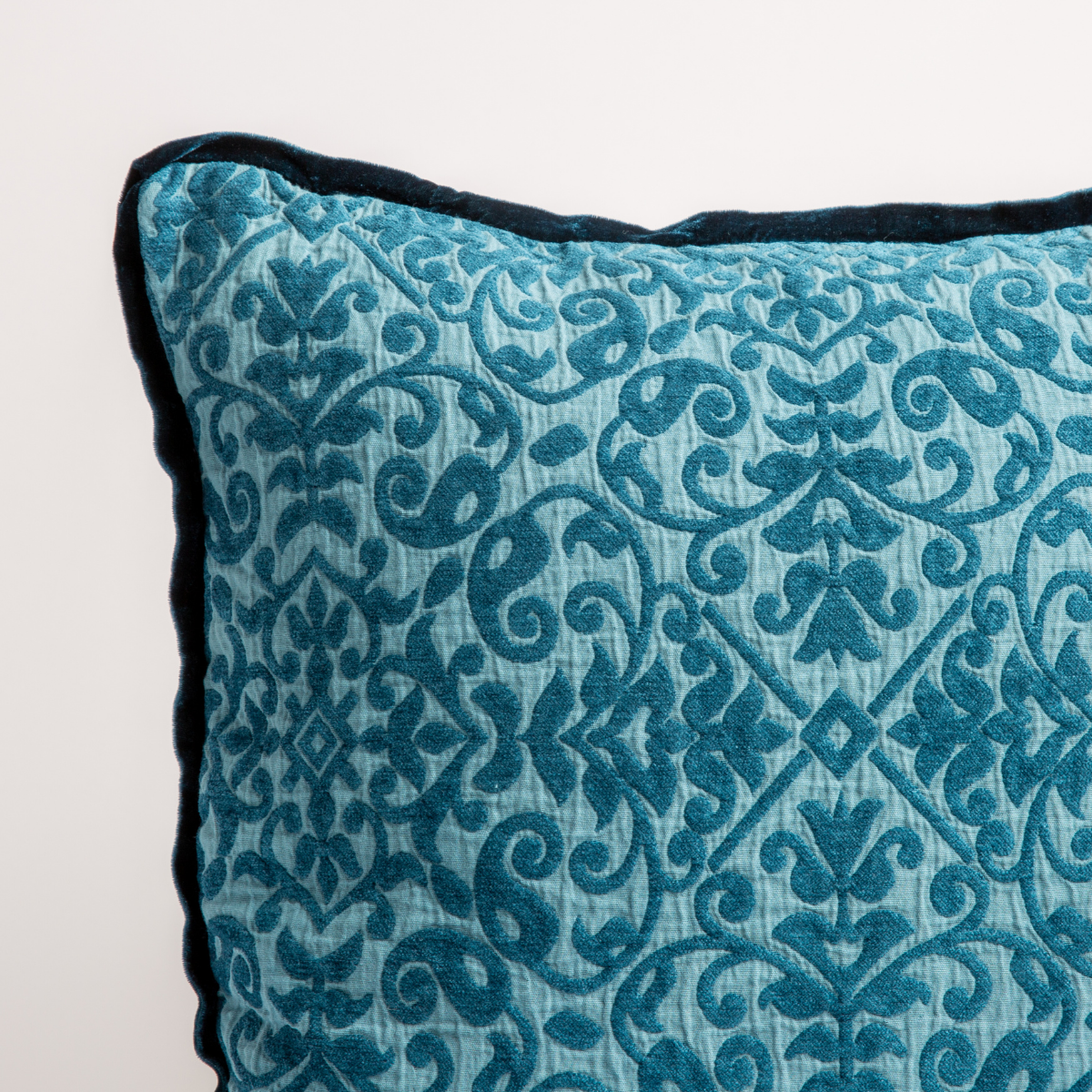 Cenote: a close up of a vienna throw pillow corner, showing trim and pattern detail — straight on against a white background. 