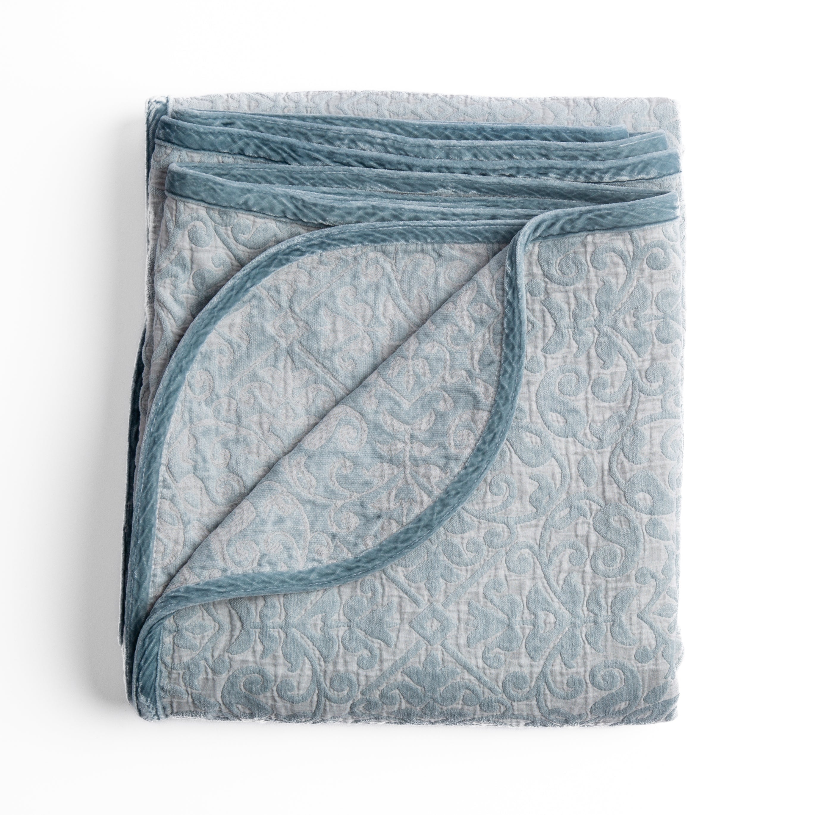 Cloud: Folded cotton chenille jacquard blanket with corner folded back — overhead on a plain white background. 