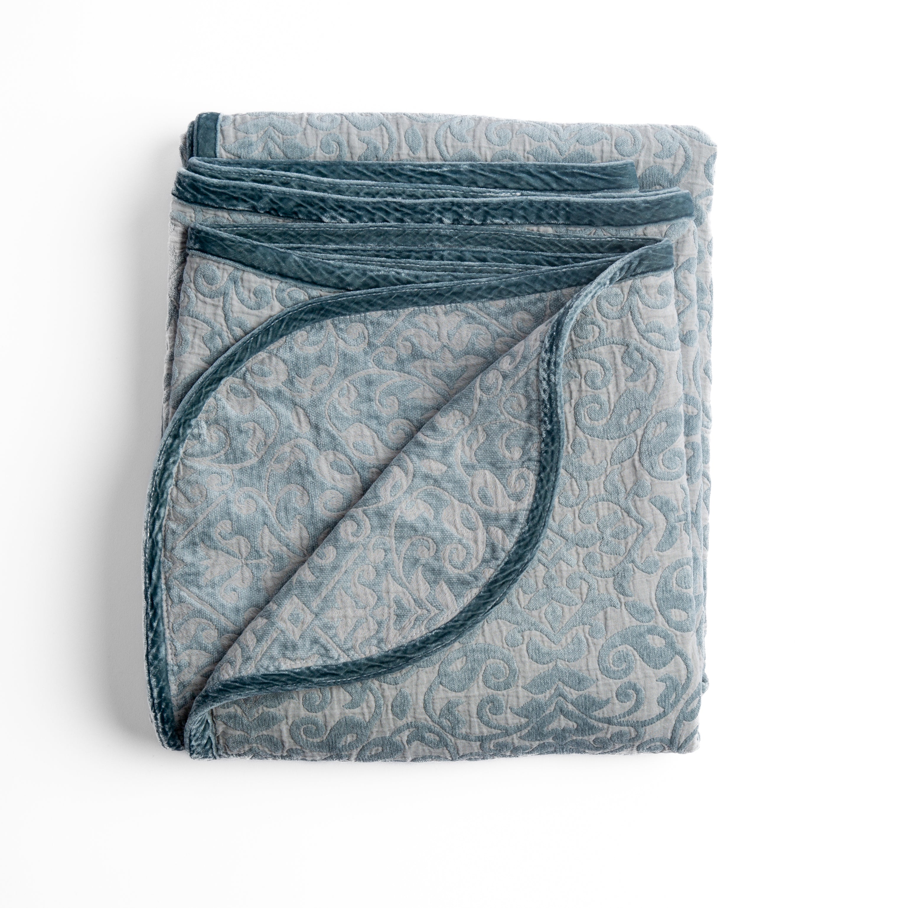 Mineral: Folded cotton chenille jacquard blanket with corner folded back — overhead on a plain white background. 