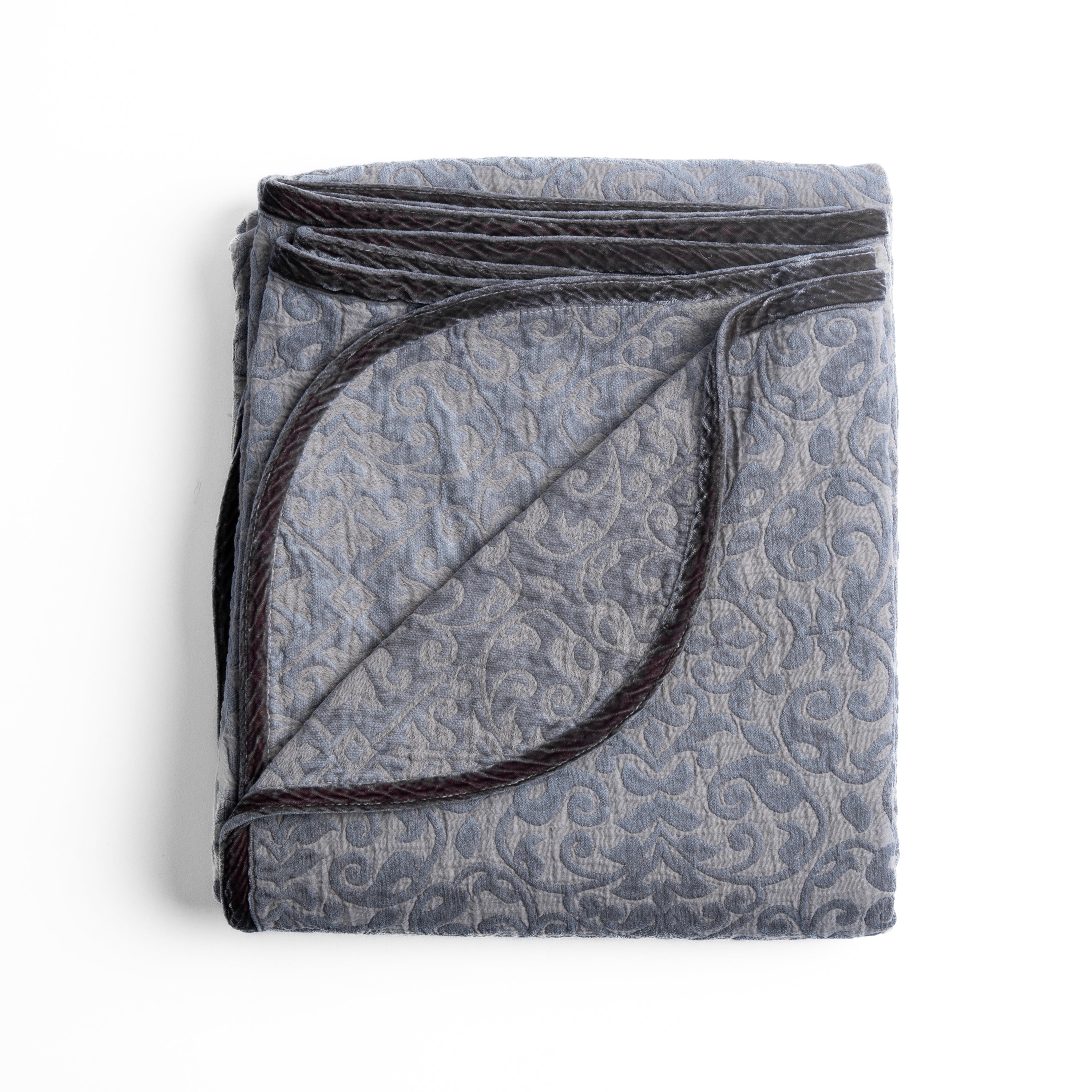 Moonlight: Folded cotton chenille jacquard blanket with corner folded back — overhead on a plain white background. 