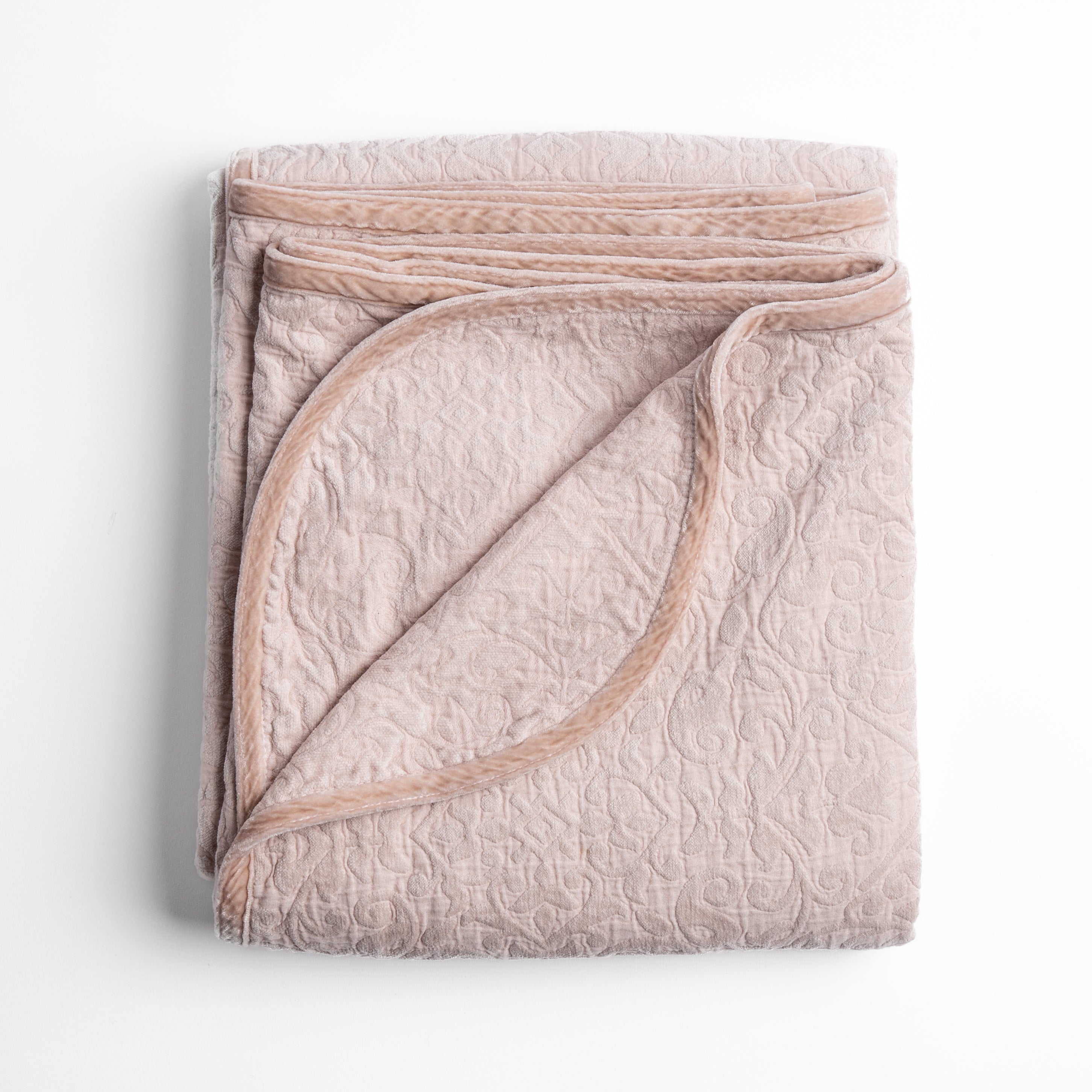 Pearl: Folded cotton chenille jacquard blanket with corner folded back — overhead on a plain white background. 